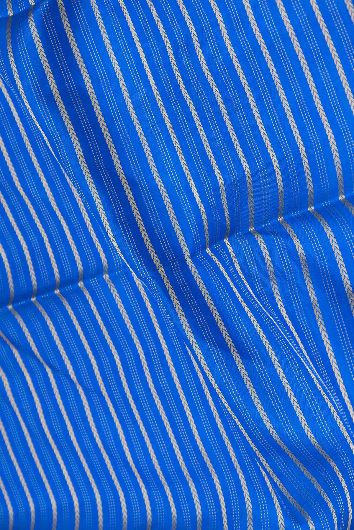 Close up of Pure Silk Pure Zari Royal Blue Dual Tone Kanchipuram Saree with Stripes on the body and Zari Border displaying folds