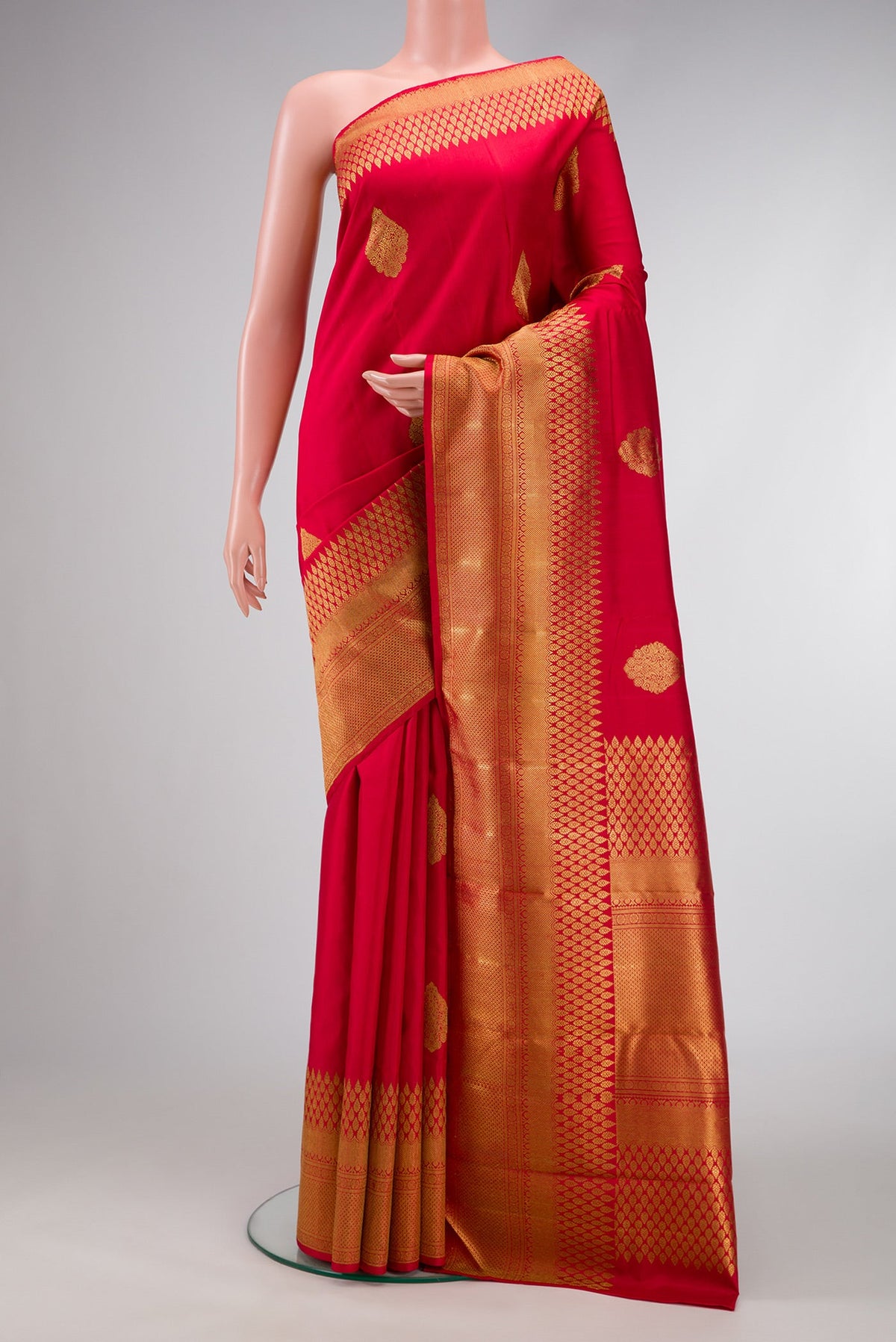Pure Silk Pure Zari Red Dual Tone Kanjivaram Saree with Zari Butta on the body and Fancy Border.  displayed on a mannequin