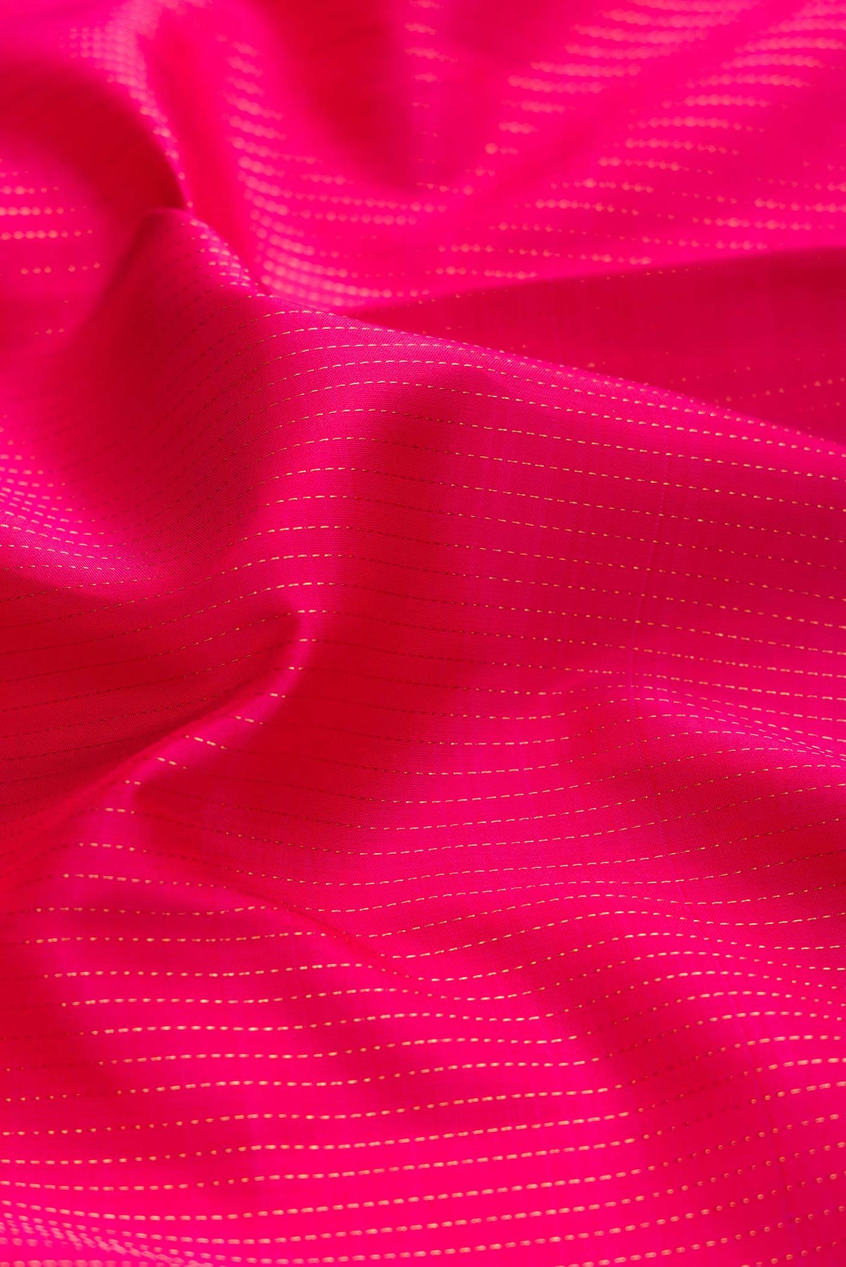 Close up of Dark Pink Dual Tone Kanchipuram Silk Saree with Stripes on the body and Zari Border displaying folds