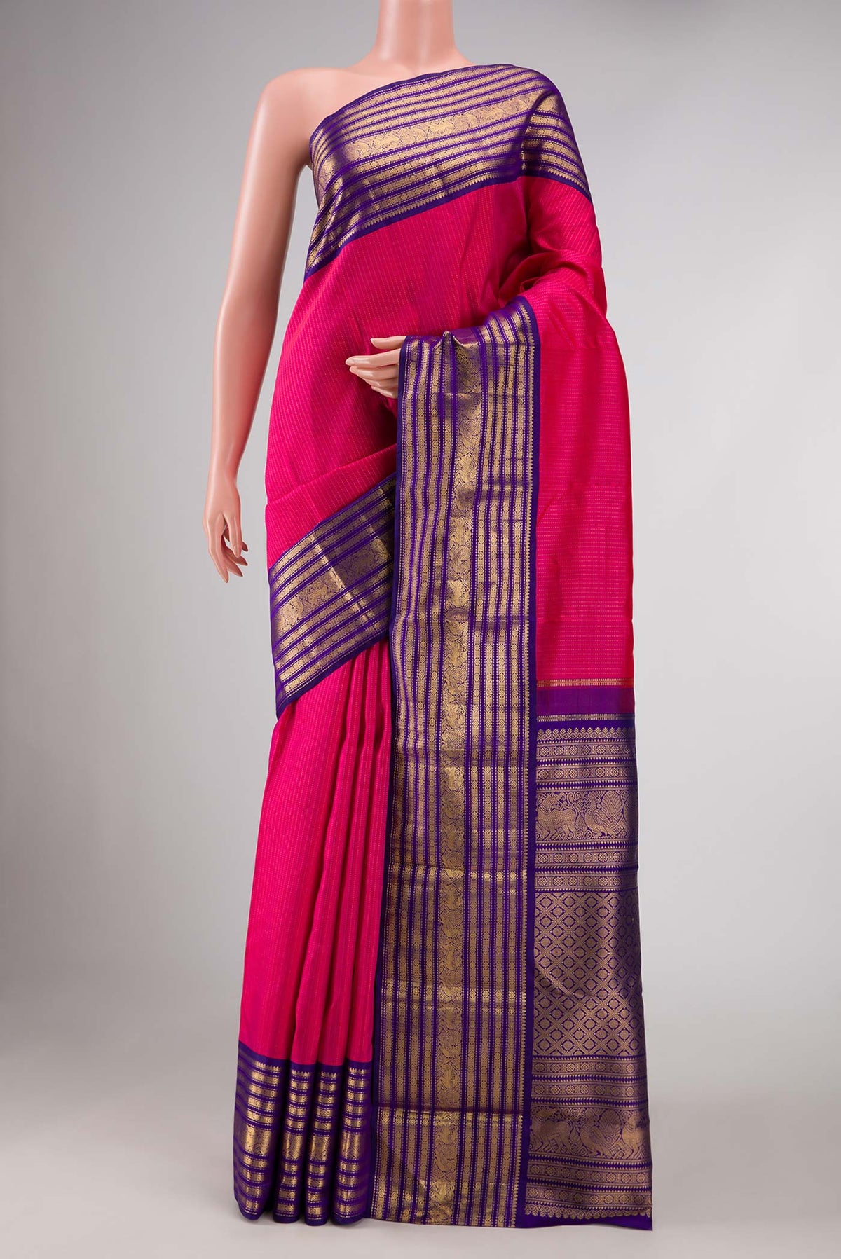 Dark Pink Dual Tone Kanchipuram Silk Saree with Stripes on the body and Zari Border displayed on a mannequin