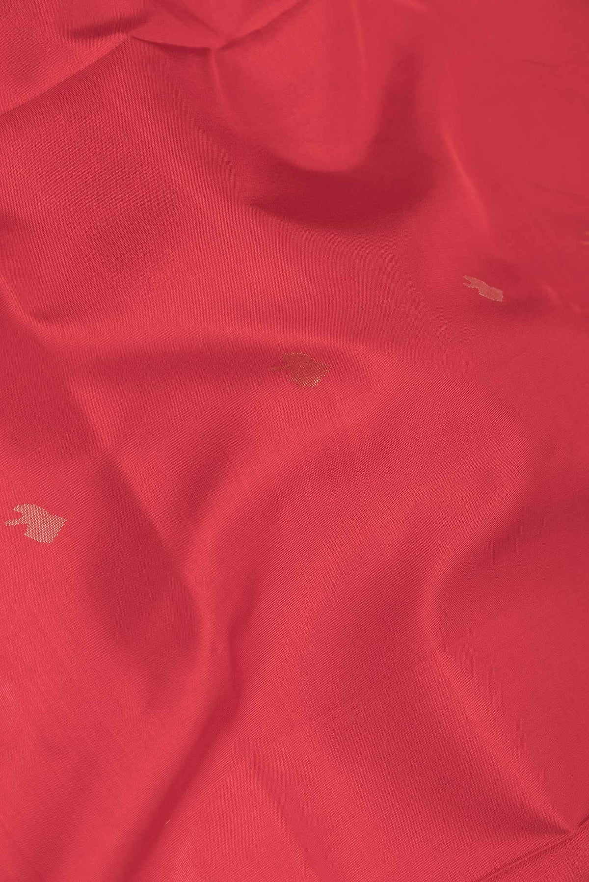 Close up of Red Dual Tone Uppada Silk Saree with Zari And Thread Butta on the body and Zari Border displaying folds