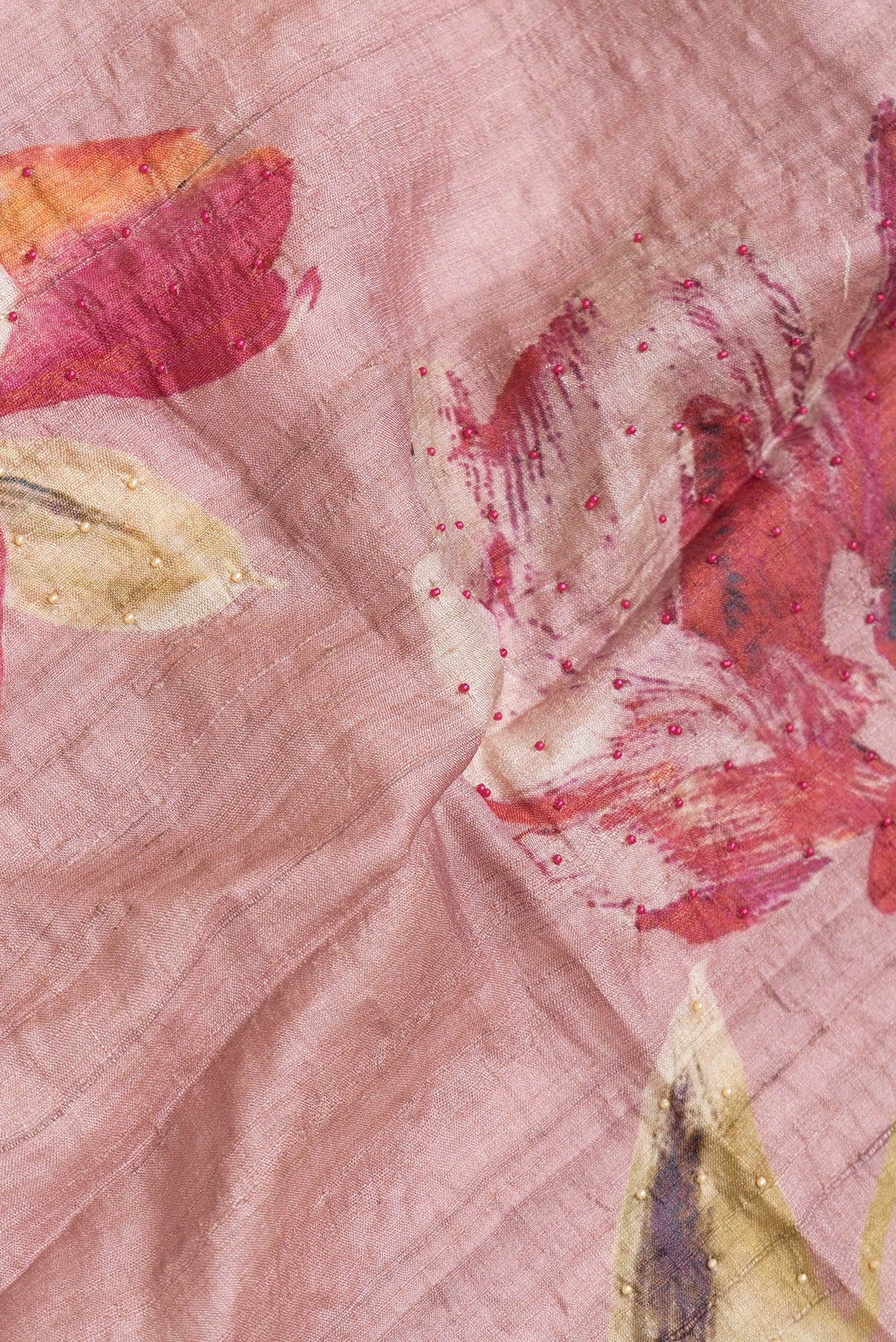 Close up of Rose Gold Dual Tone Tussar Silk Saree with Embroidery on the body and Embroidery Border.  displaying folds