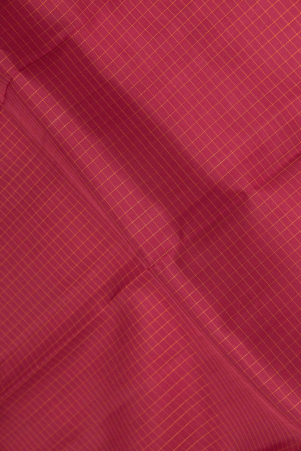 Close up of Maroon Dual Tone Kanchipuram Silk Saree with Checked design on the body and Zari Border displaying folds