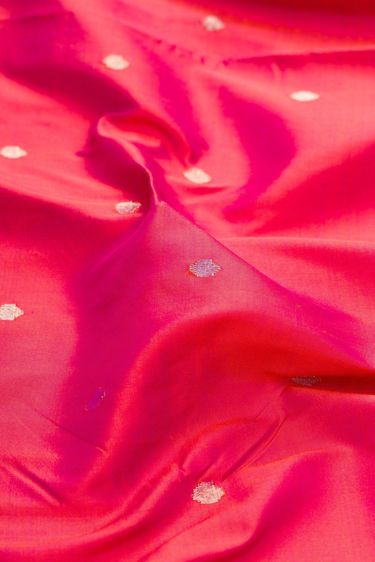 Close up of Pink Dual Tone Paithani Silk Saree with Zari Butta on the body and Paithani Border.  displaying folds