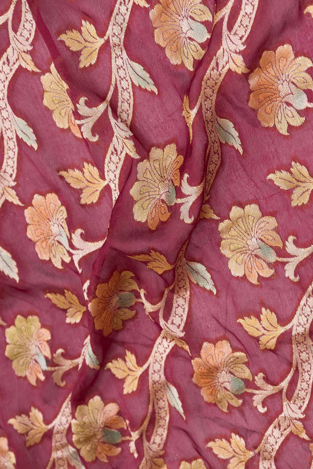 Close up of Maroon Dual Tone Georgette Saree with Zari Brocade on the body and Zari Border displaying folds