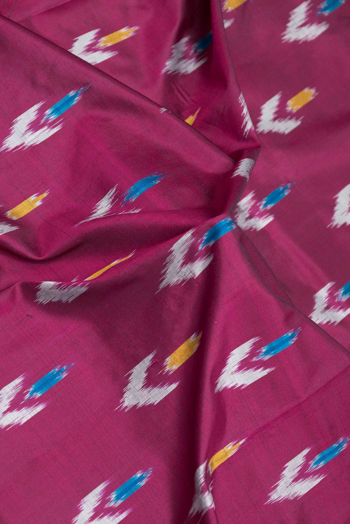 Close up of Pink Dual Tone Pochampally Silk Saree with Ikat Print on the body and Ikat Border displaying folds
