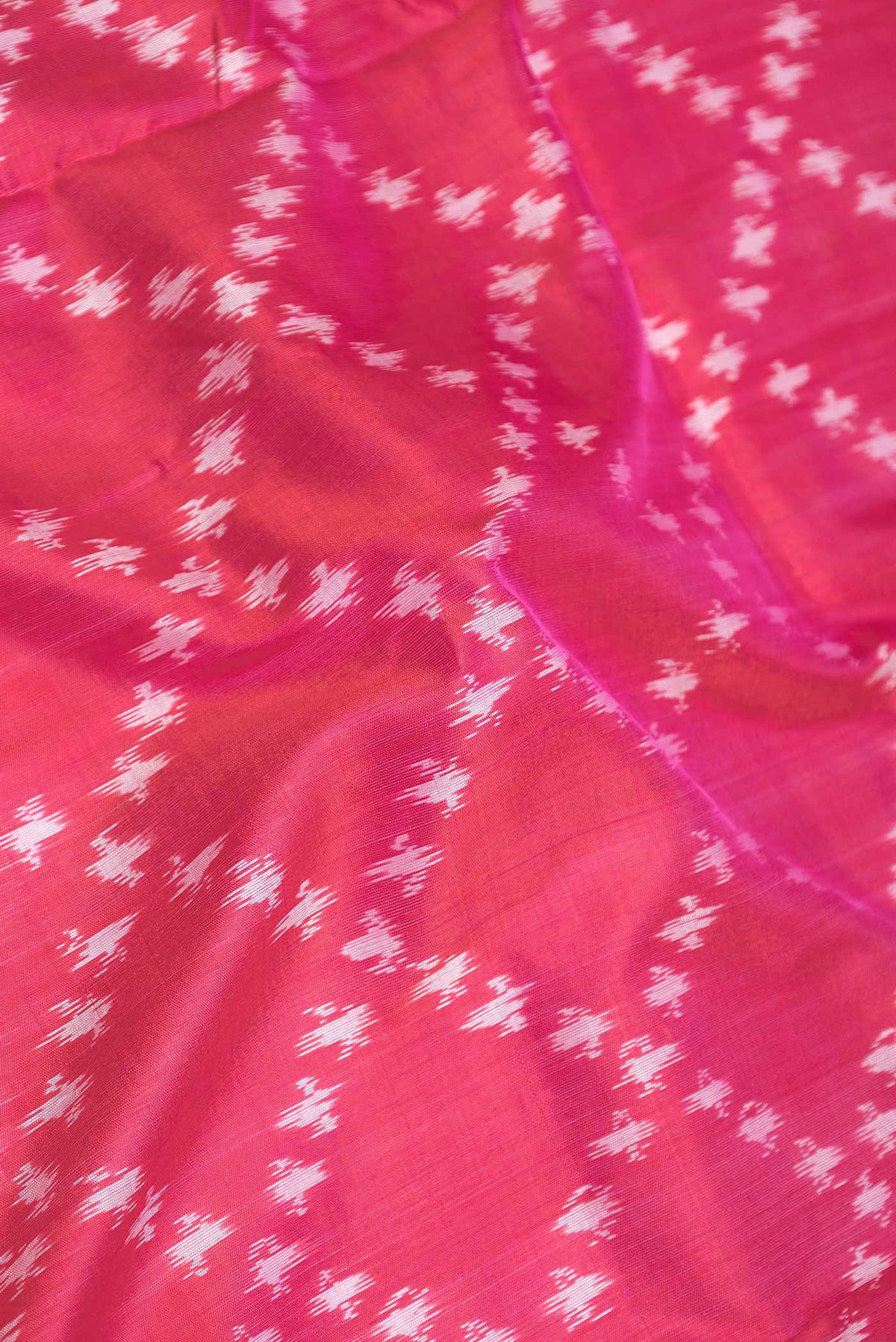 Close up of Pink Dual Tone Pochampally Silk Saree with Ikat Print on the body and Ikat Border displaying folds