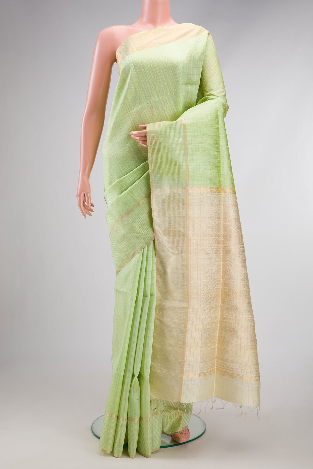 Pista Green Raw Silk Saree with Checked design on the body and Zari Border.  displayed on a mannequin