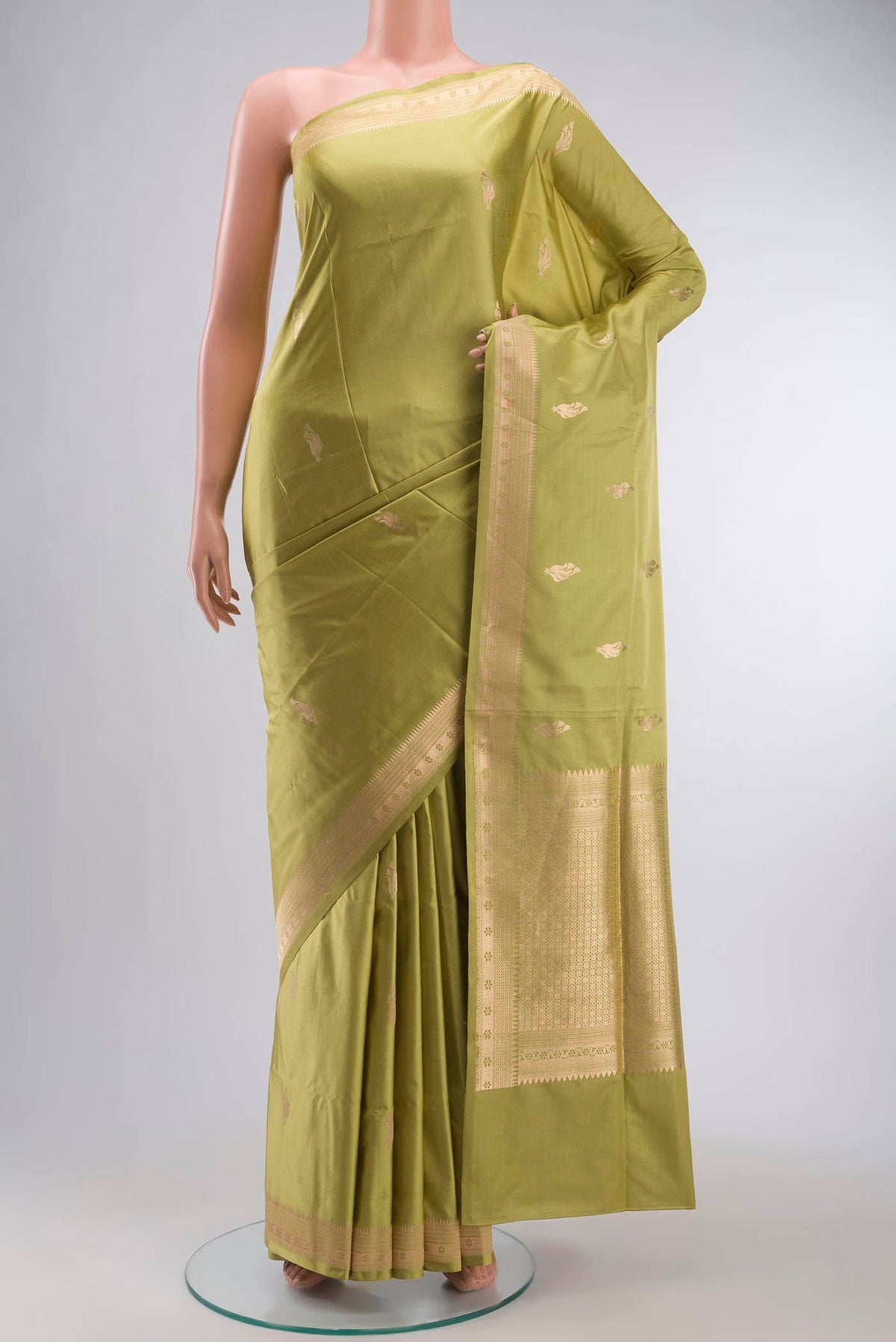 Green Banarasi Silk Saree with Zari Butta on the body and Zari Border displayed on a mannequin