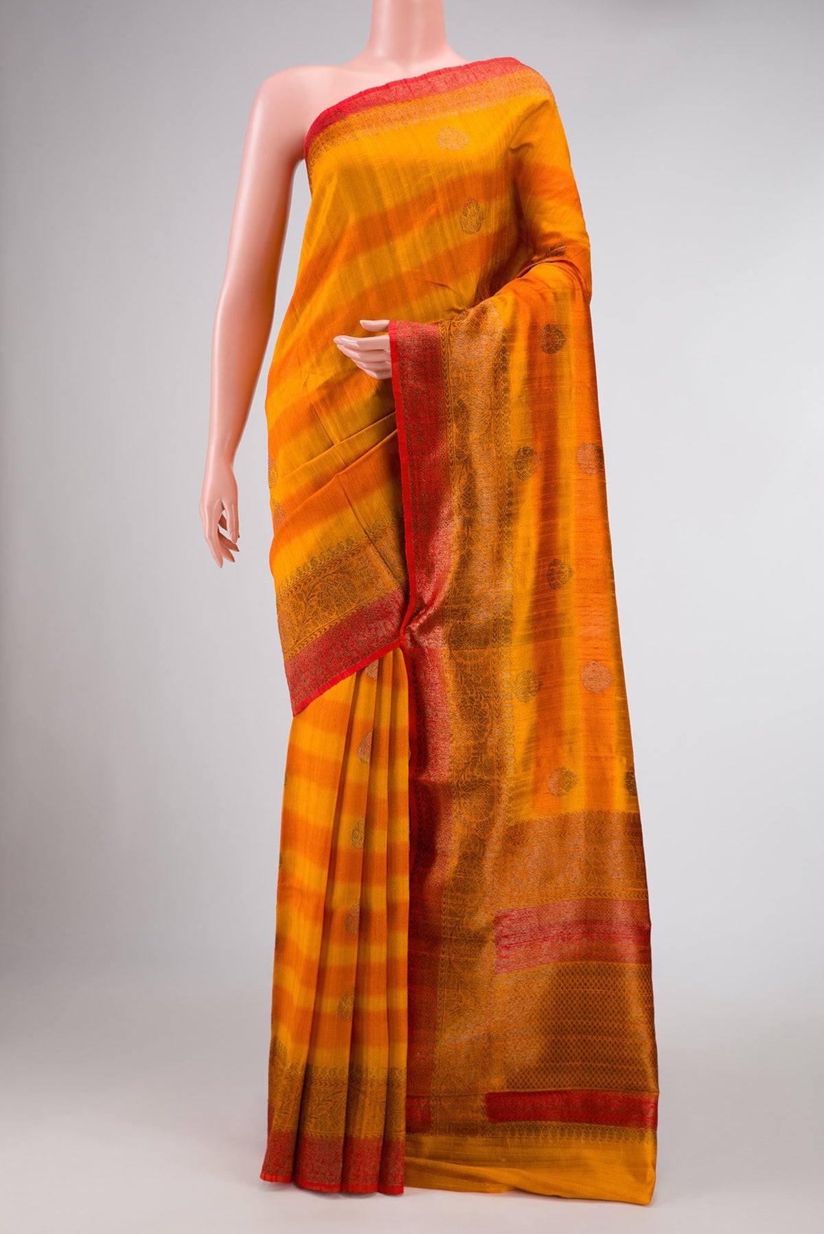 Mustard Banarasi Tussar Silk Saree with Zari Butta on the body and Zari Border displayed on a mannequin