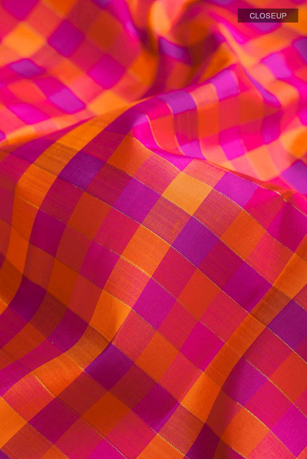 Close up of Multicolor Kanchipuram Silk Saree Checked design on the body and Zari Border displaying folds