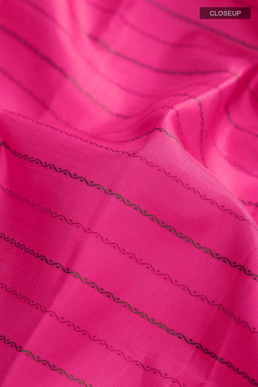 Close up of Pink Kanchipuram Silk Saree with Stripes on the body and Zari Border displaying folds