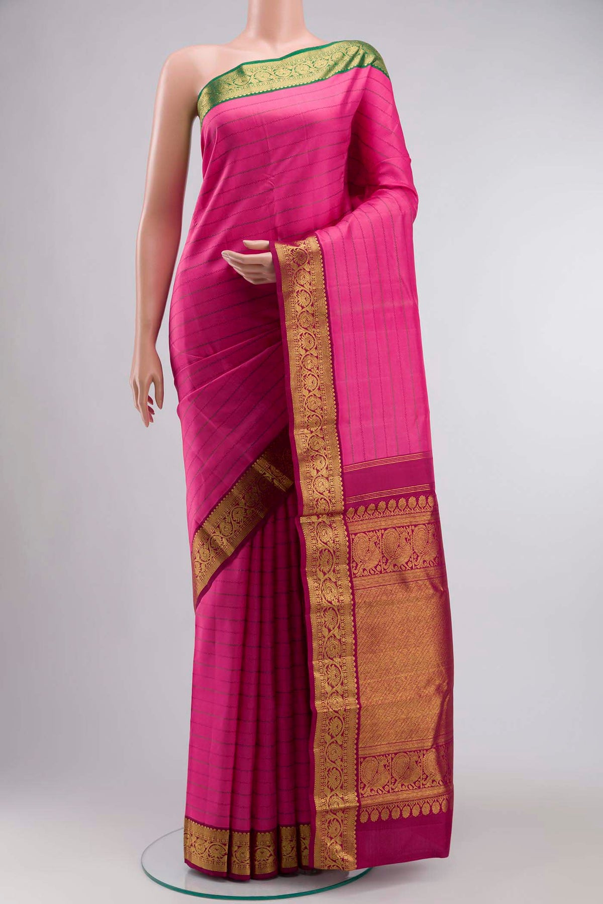 Pink Kanchipuram Silk Saree with Stripes on the body and Zari Border displayed on a mannequin