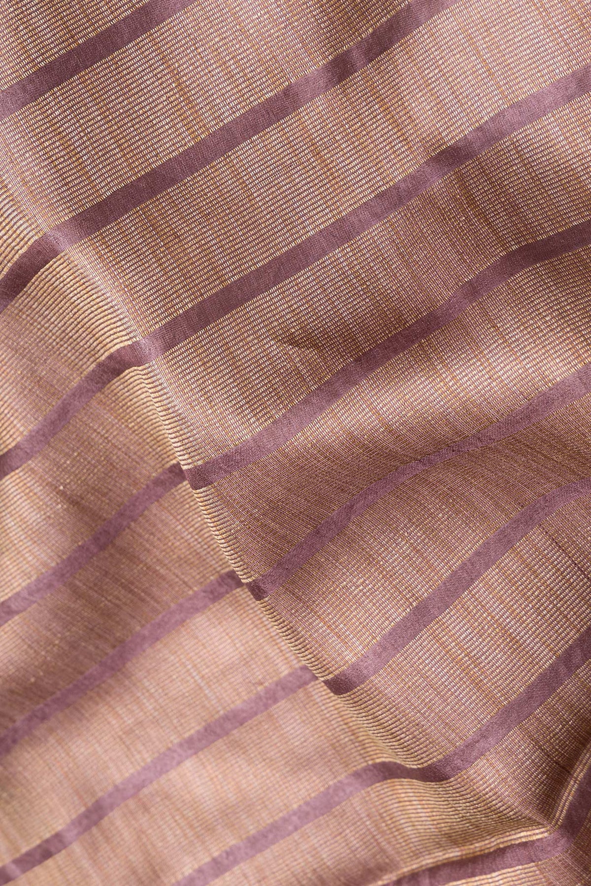 Close up of Maroon Dual Tone Tussar Silk Saree with Stripes on the body and Embroidery Border.  displaying folds