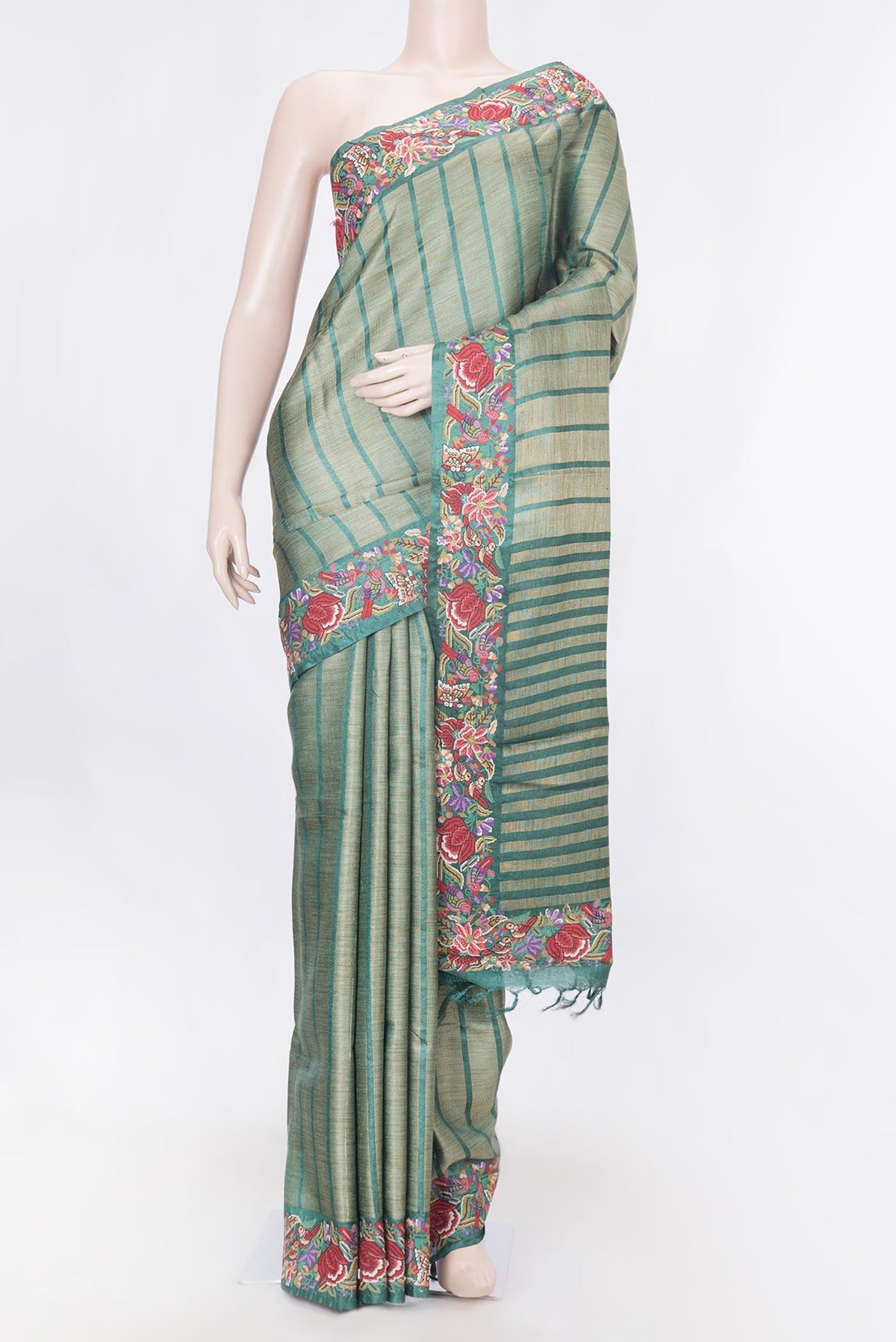 Green Dual Tone Tussar Silk Saree with Stripes on the body and Embroidery Border displayed on a mannequin