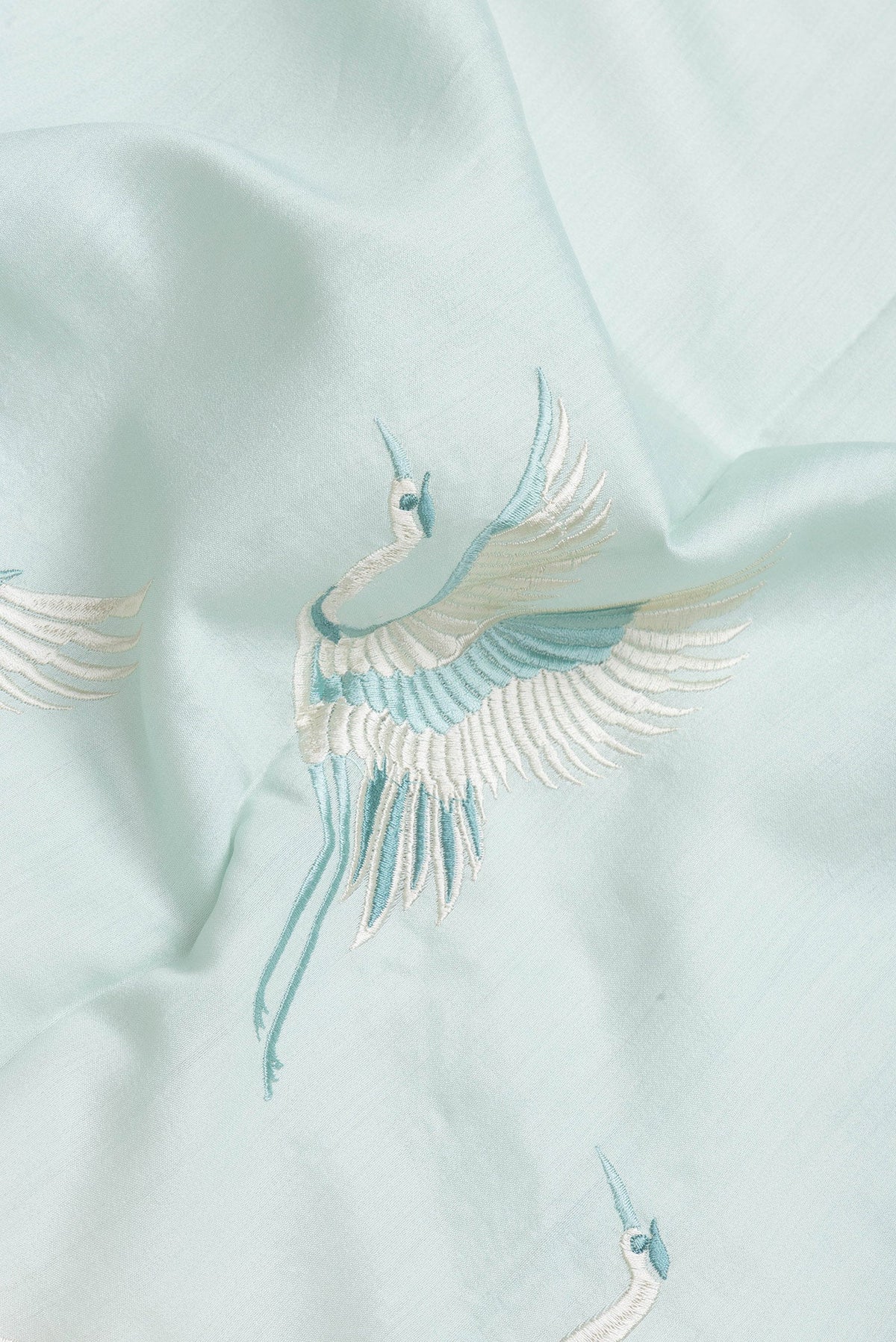 Close up of Light Blue Dual Tone Tussar Silk Saree with Plain Body and Fancy Border.  displaying folds