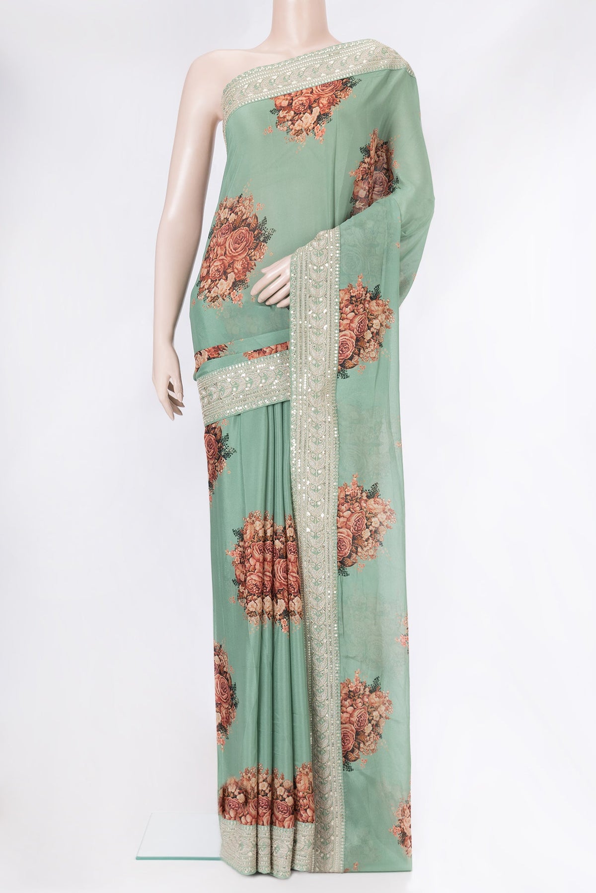 Sea Green Dual Tone Mysore Georgette Saree with Printed design on the body and Embroidery Border.  displayed on a mannequin