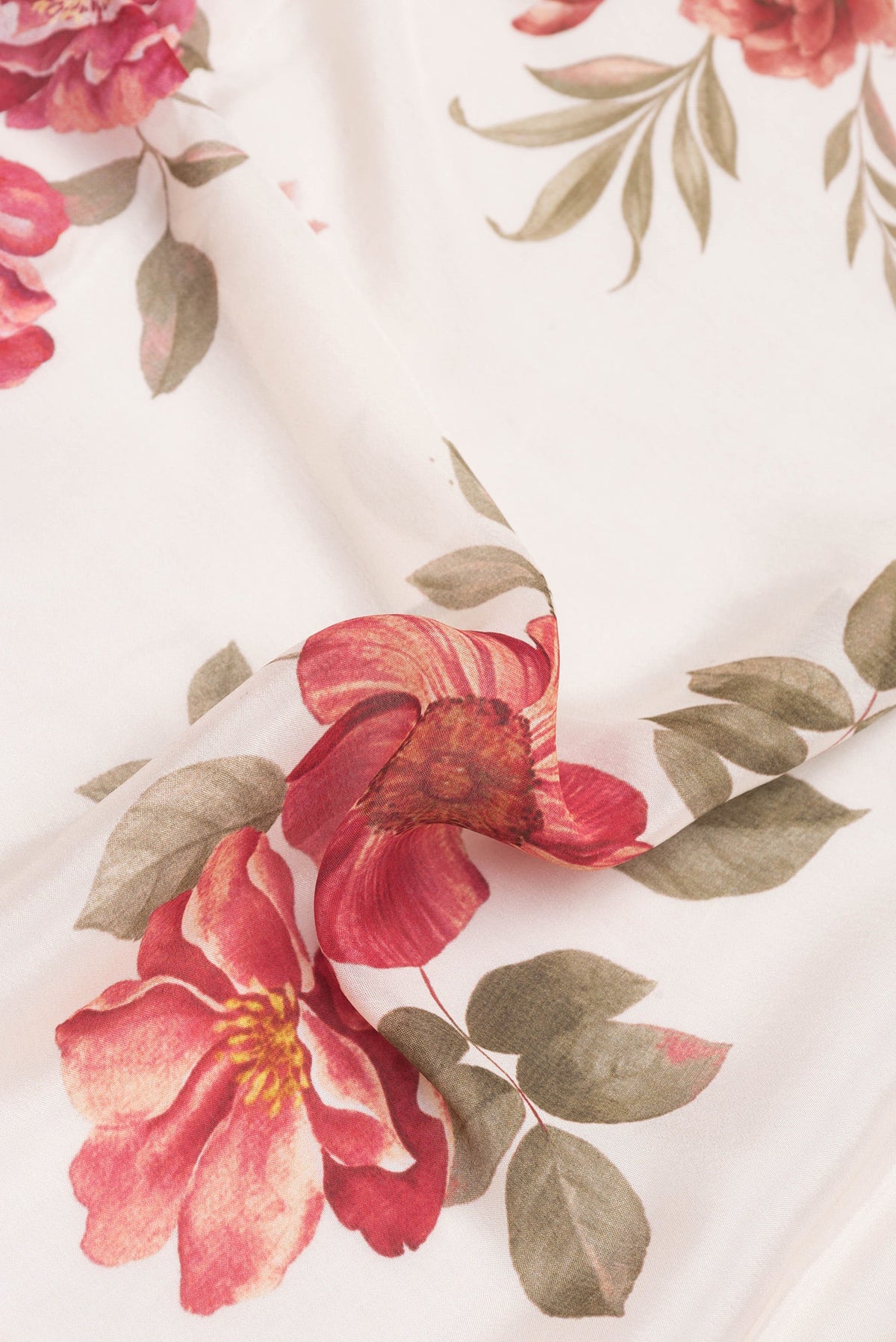 Close up of Golden Peach Dual Tone Georgette Saree with Printed design on the body and Embroidery Border.  displaying folds
