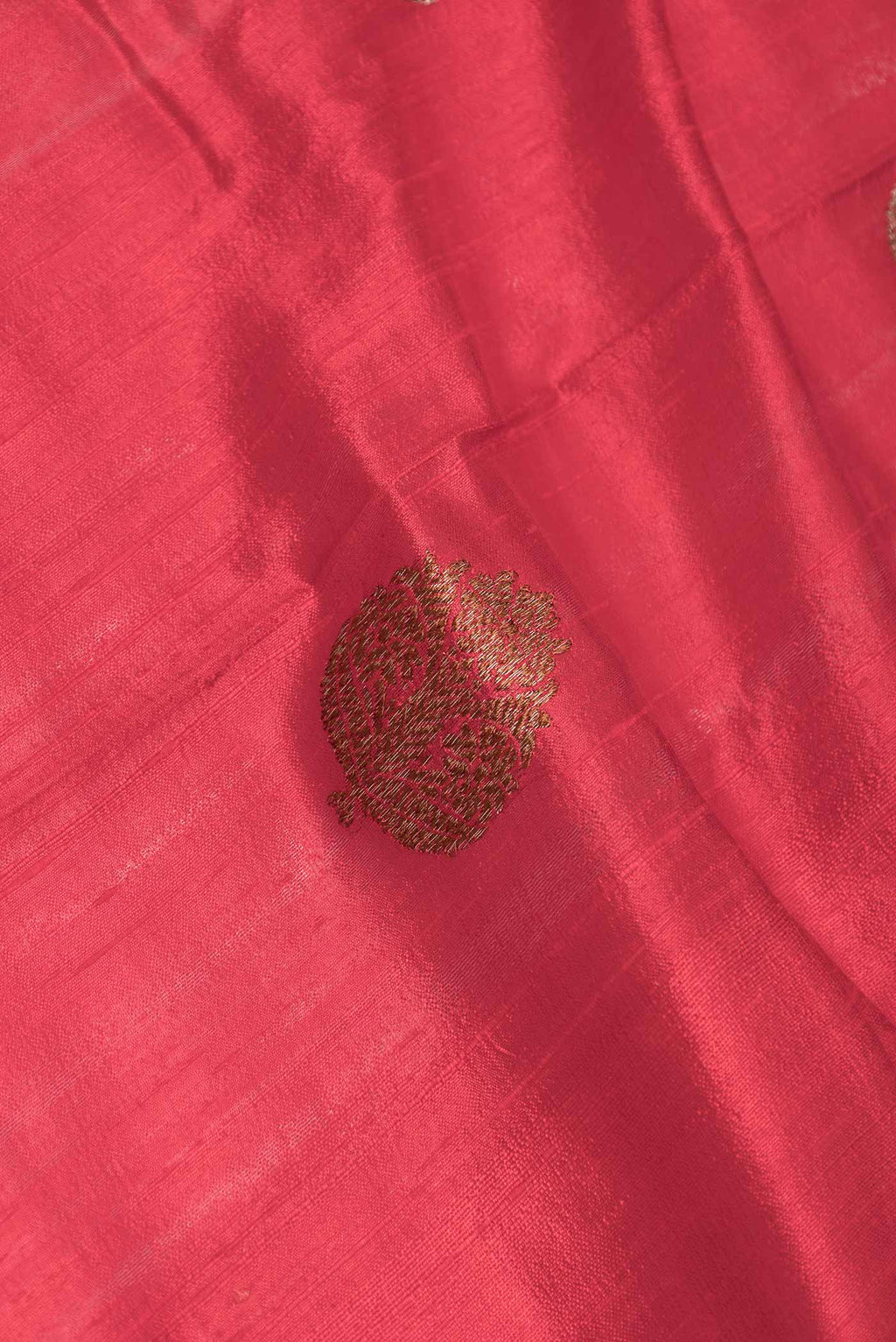 Close up of Red Dual Tone Raw Silk Saree with Zari Butta on the body and Zari Border displaying folds