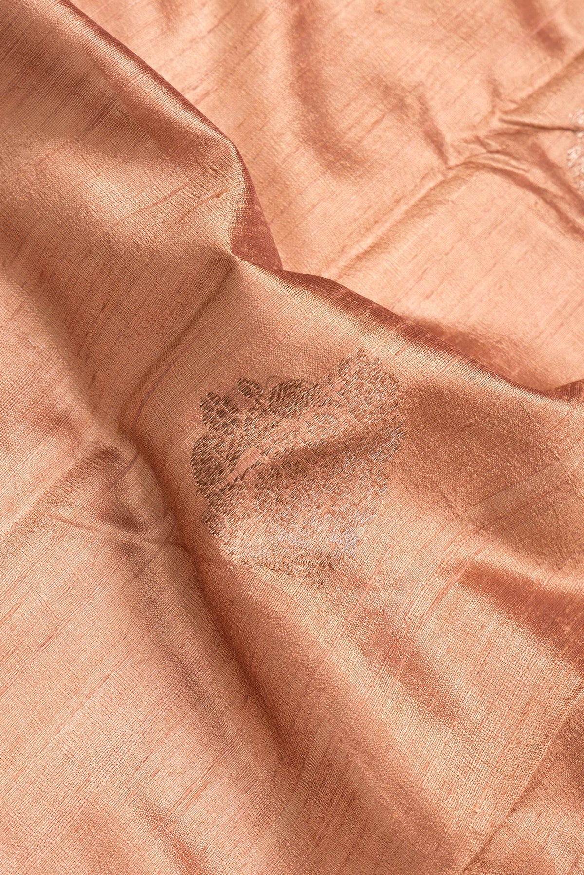 Close up of Brown Dual Tone Raw Silk Saree with Zari Butta on the body and Zari Border.  displaying folds