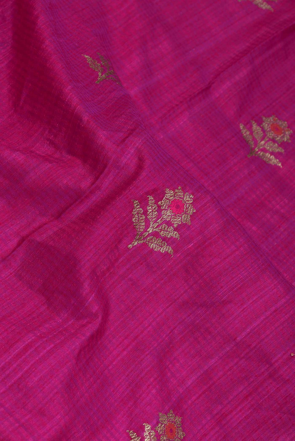 Close up of Pink Dual Tone Raw Silk Saree with Zari Butta on the body and Zari Border displaying folds