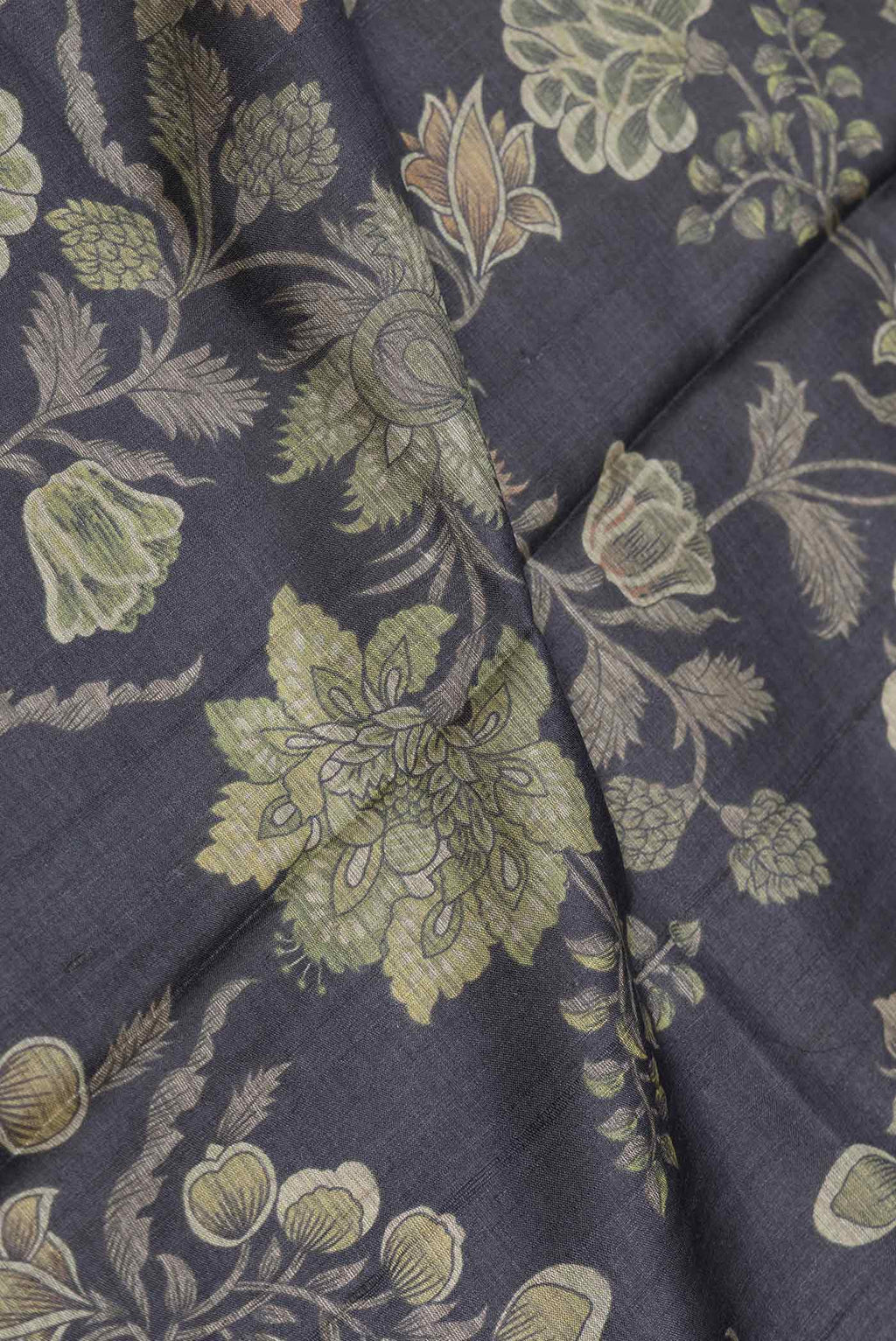 Close up of Black Dual Tone Tussar Saree with Printed design on the body and Embroidery Border displaying folds