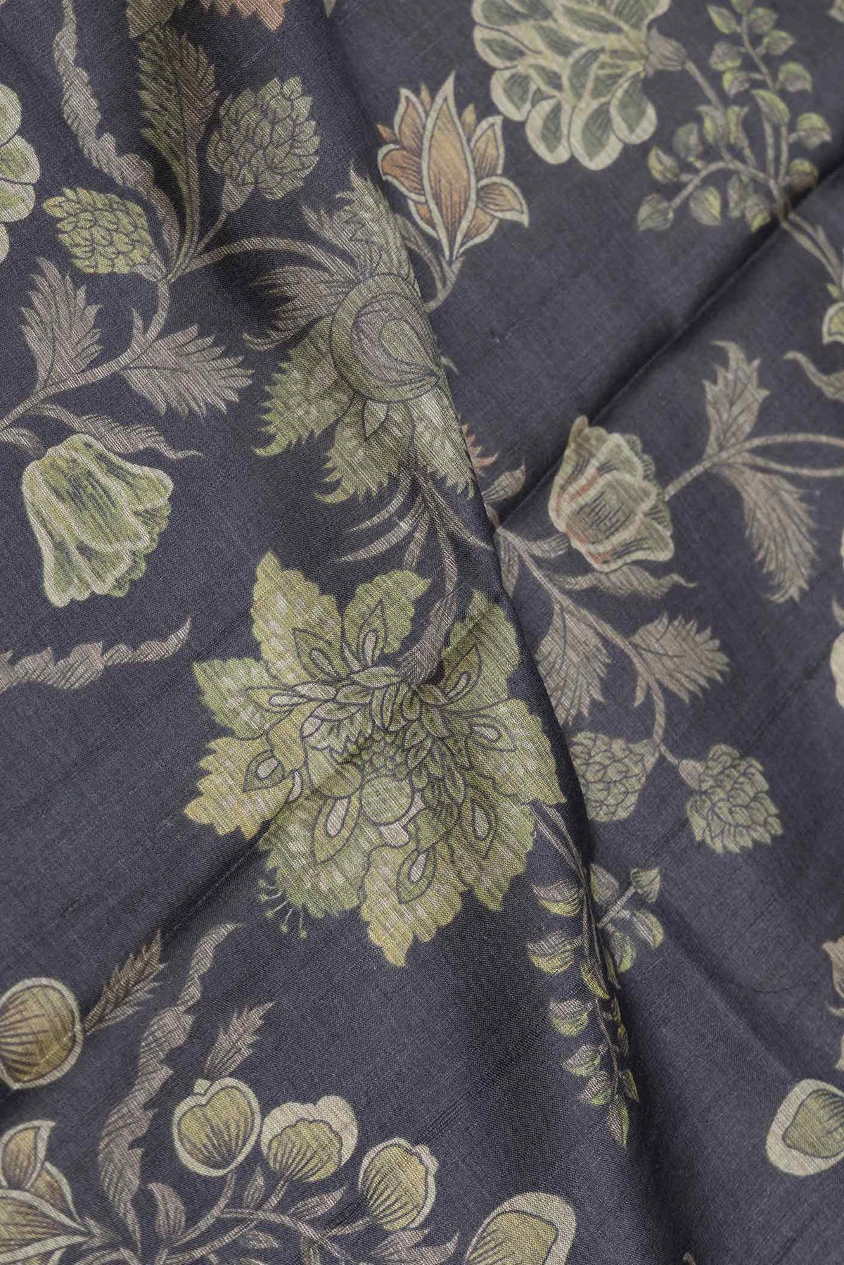 Close up of Black Dual Tone Tussar Saree with Printed design on the body and Embroidery Border displaying folds