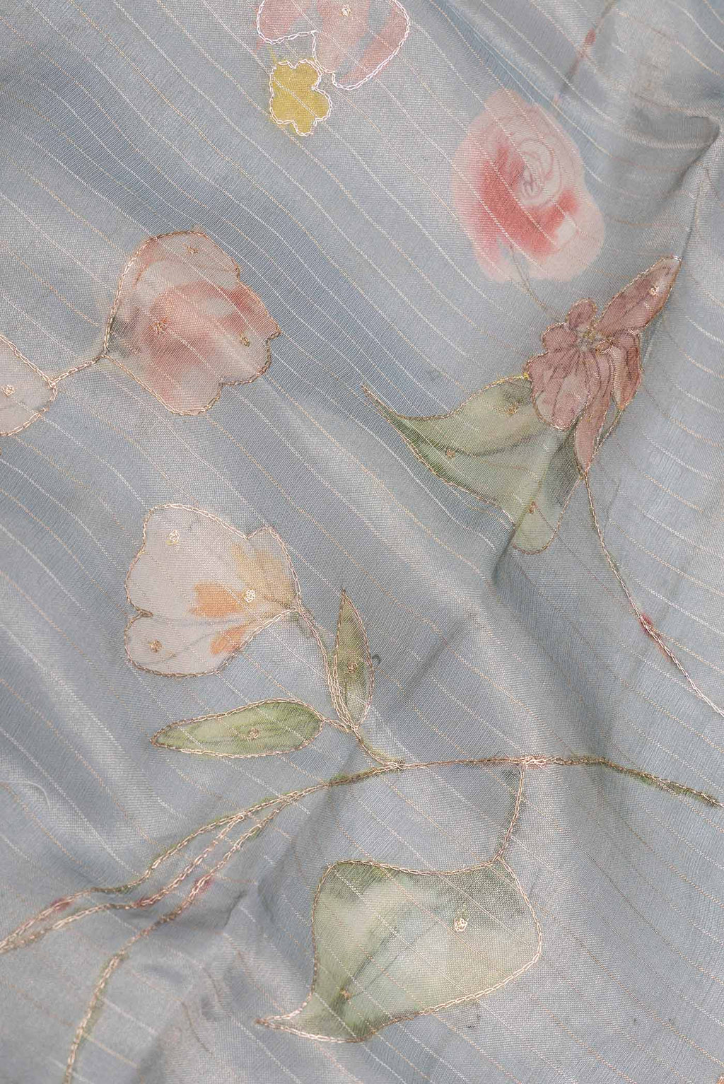 Close up of Blue Grey Organza Silk Saree with Embroidery on the body and Embroidery Border displaying folds