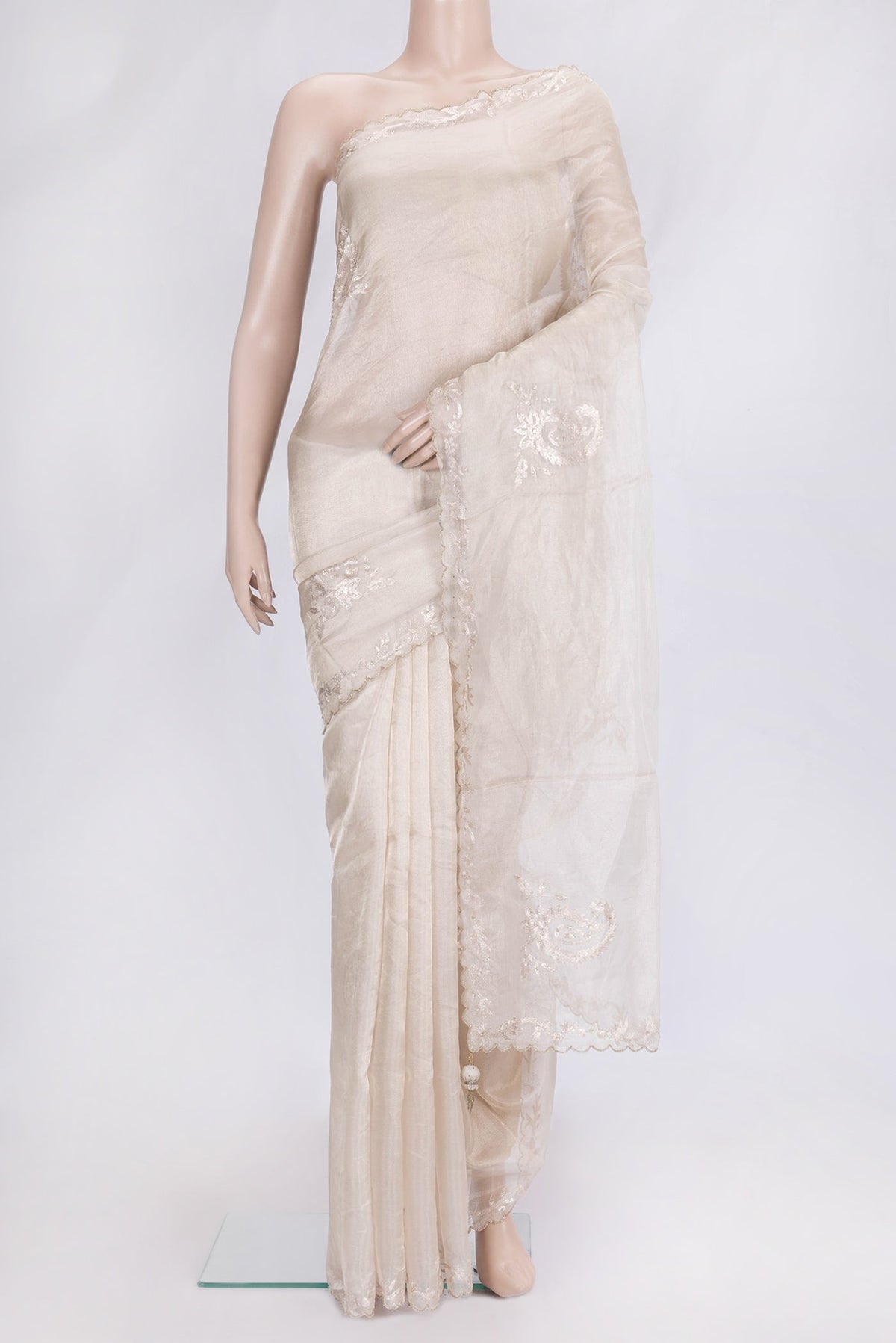 Beige Dual Tone Organza Silk Saree with Embroidery on the body and Embroidery Border.  displayed on a mannequin