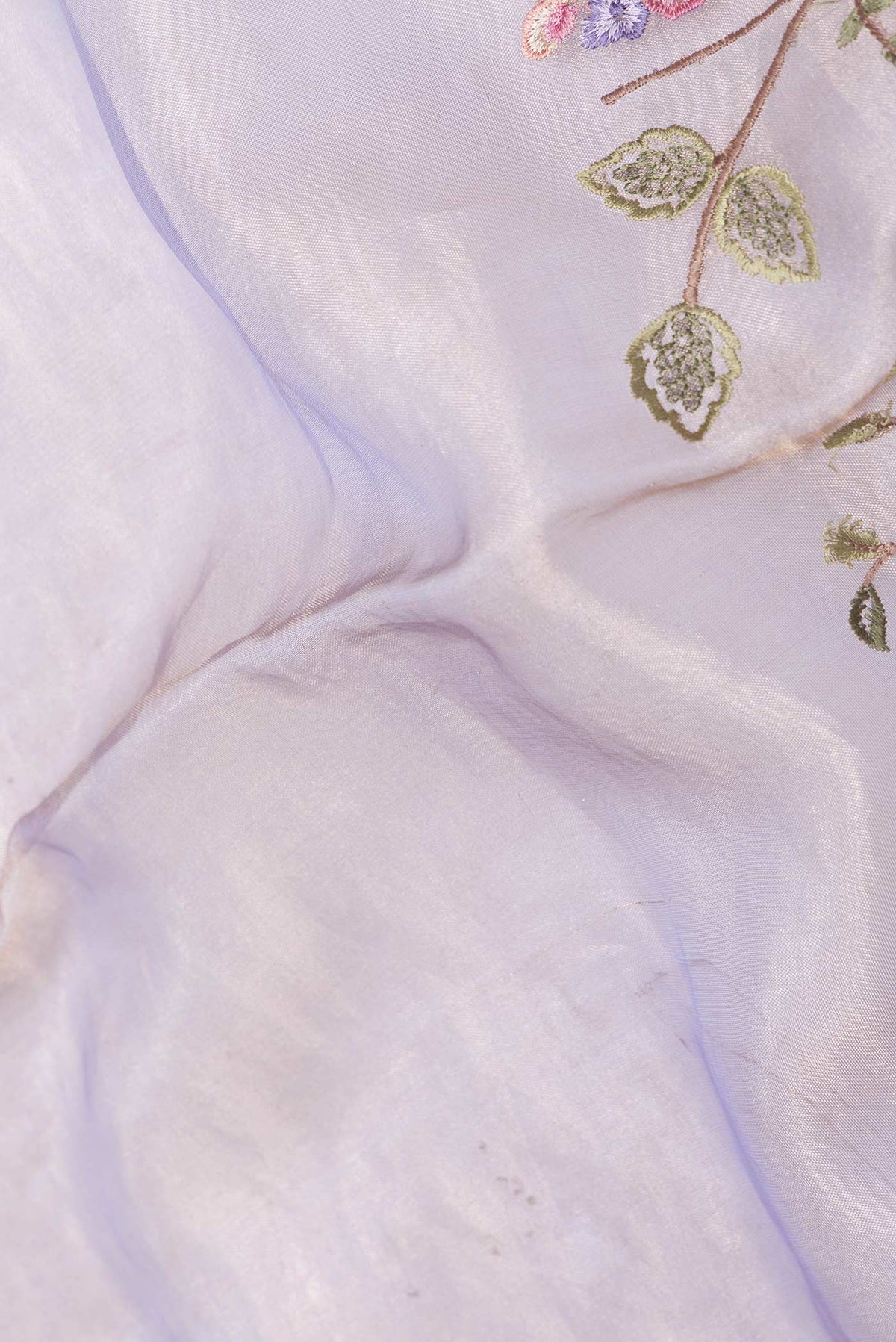 Close up of Lavender Dual Tone Organza Silk Saree with Embroidery on the body and Zari Border displaying folds