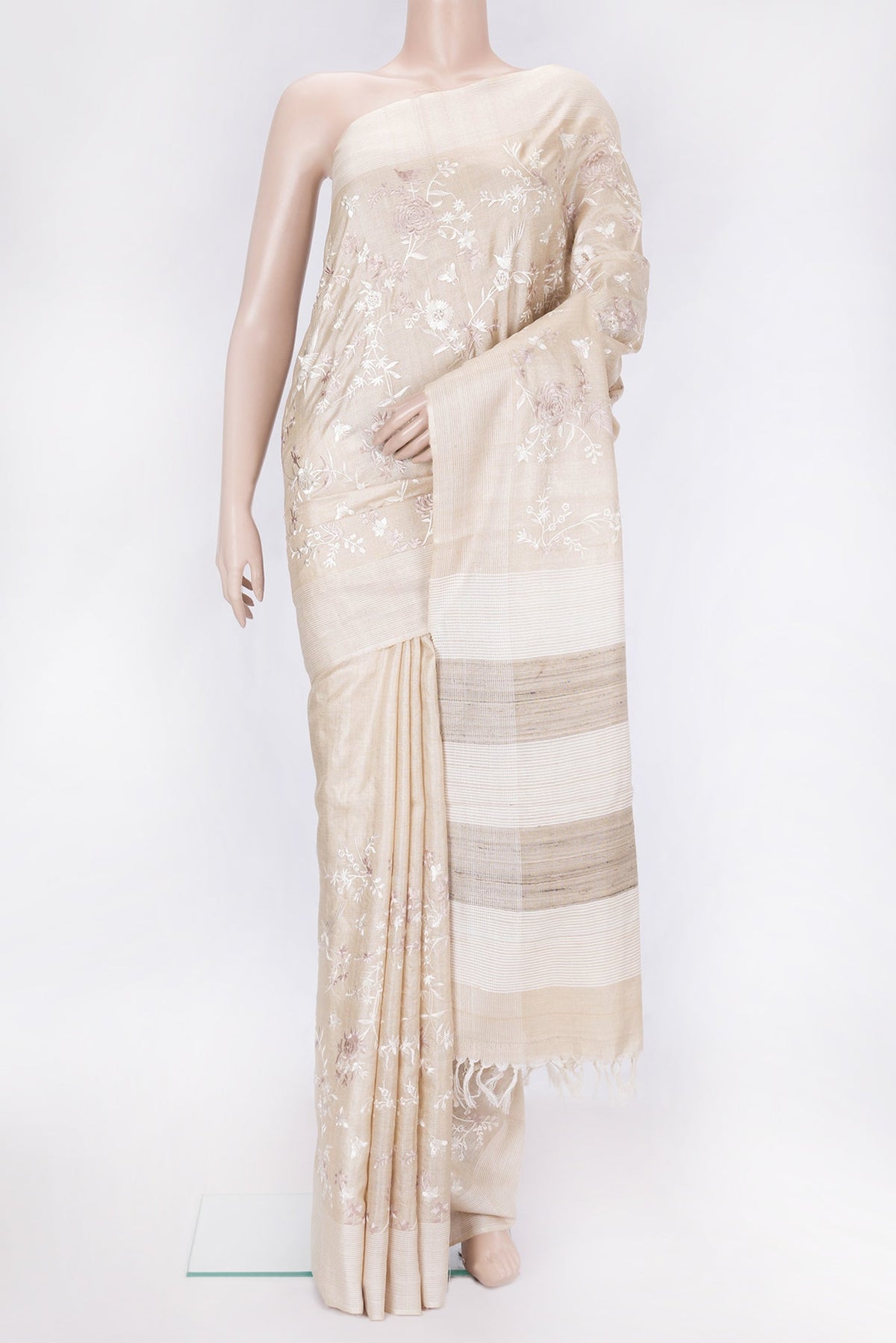 Beige Dual Tone Tussar Silk Saree with Embroidery on the body and Thread Border.  displayed on a mannequin