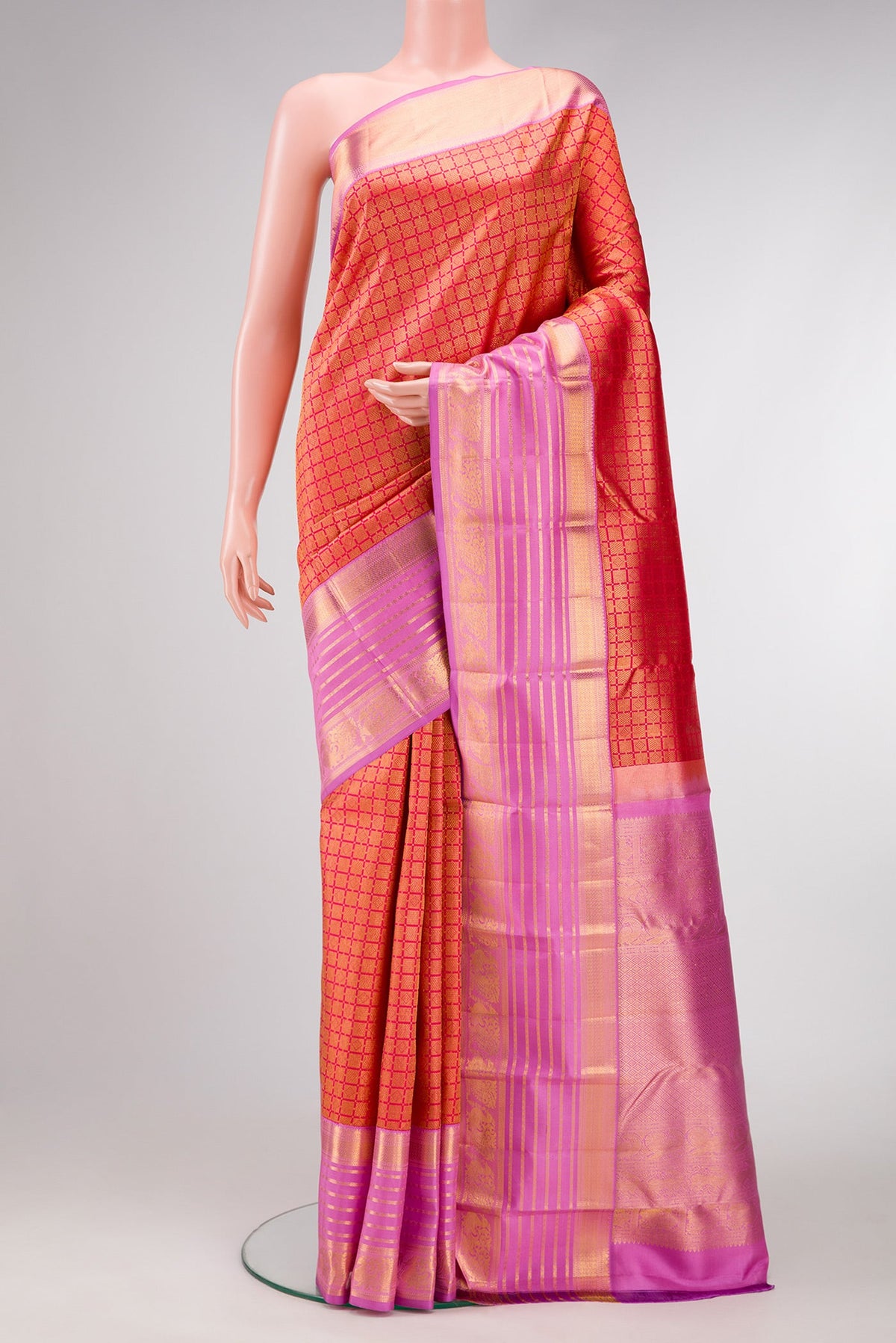 Brick Orange Dual Tone Kanjivaram Silk Saree with Zari Brocade on the body and Zari Border.  displayed on a mannequin