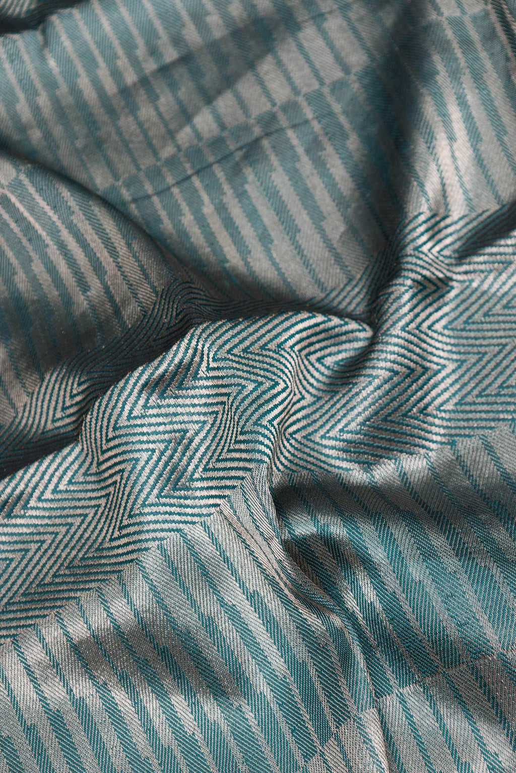 Close up of Green Dual Tone Banarasi Silk Saree with Zari Brocade on the body and Zari Border.  displaying folds