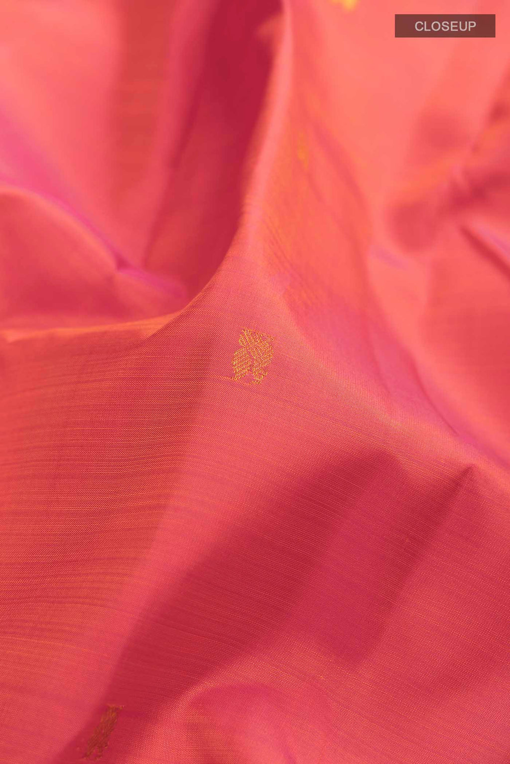 Close up of Pink Kanchipuram Silk Saree with Zari Butta on the body and Zari Border displaying folds