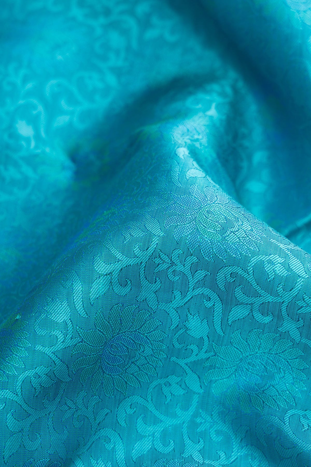 Close up of Sky Blue Dual Tone Kanchipuram Silk Saree with Jacquard design on the body and Zari Border.  displaying folds