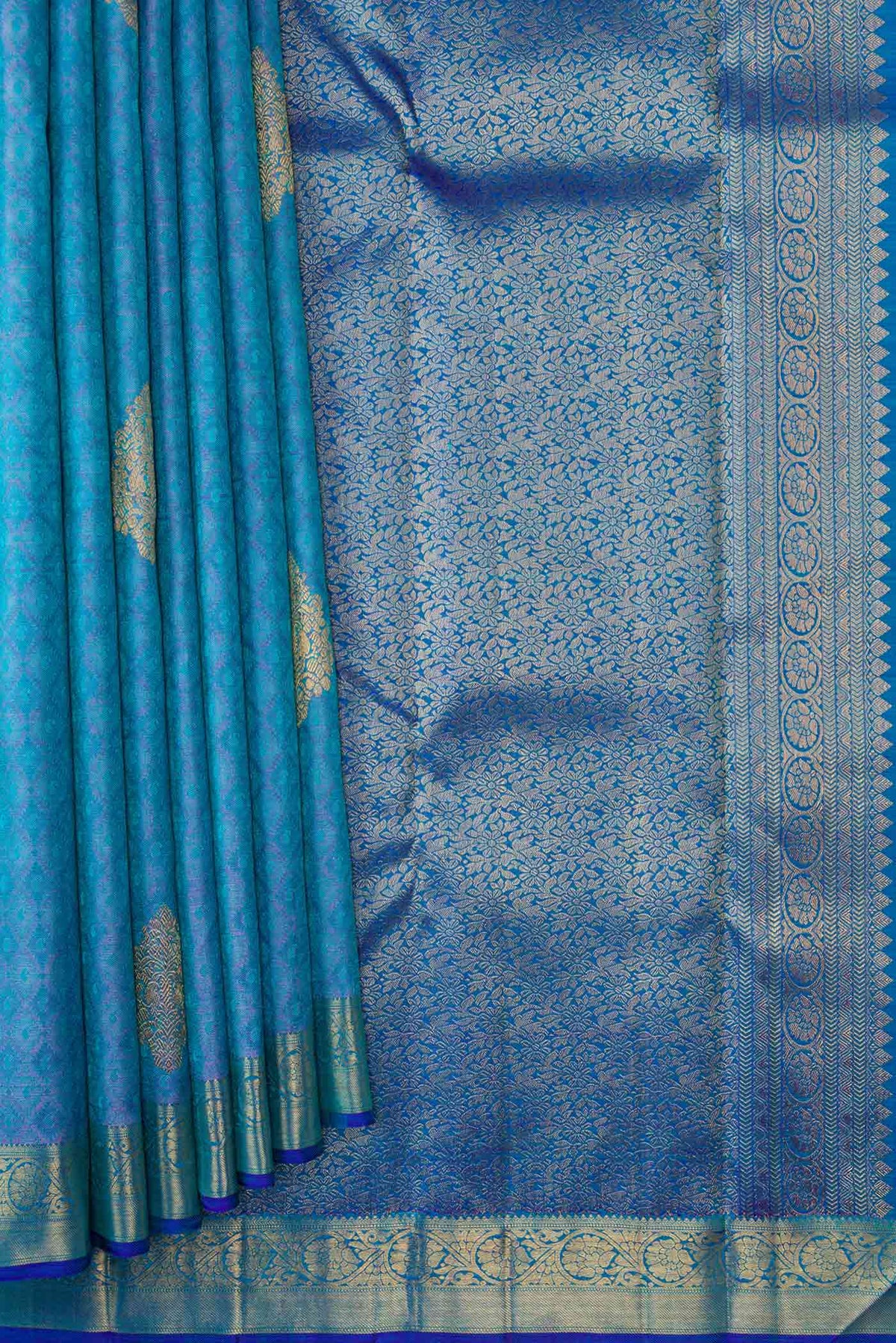 Pleats and pallu of Pure Silk Pure Zari Peacock Blue Dual Tone Kanchipuram Saree with Jacquard With Zari Butta on the body and Zari Border. 