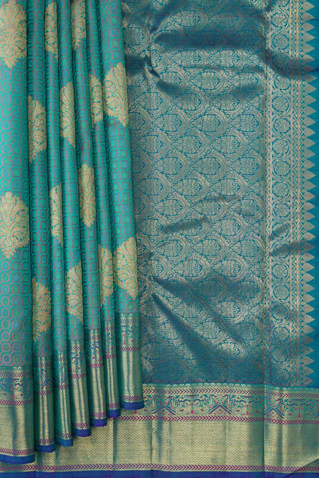 Pleats and pallu of Pure Silk Pure Zari Peacock Blue Dual Tone Kanchipuram Saree with Jacquard With Zari Butta on the body and Zari Border. 