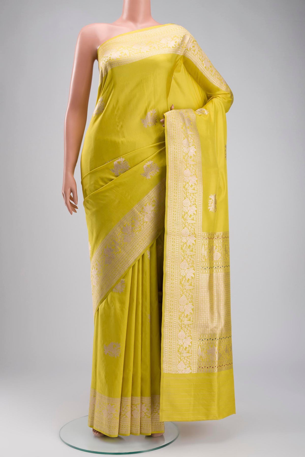 Yellow Banarasi Silk Saree with Zari Butta on the body and Zari Border displayed on a mannequin