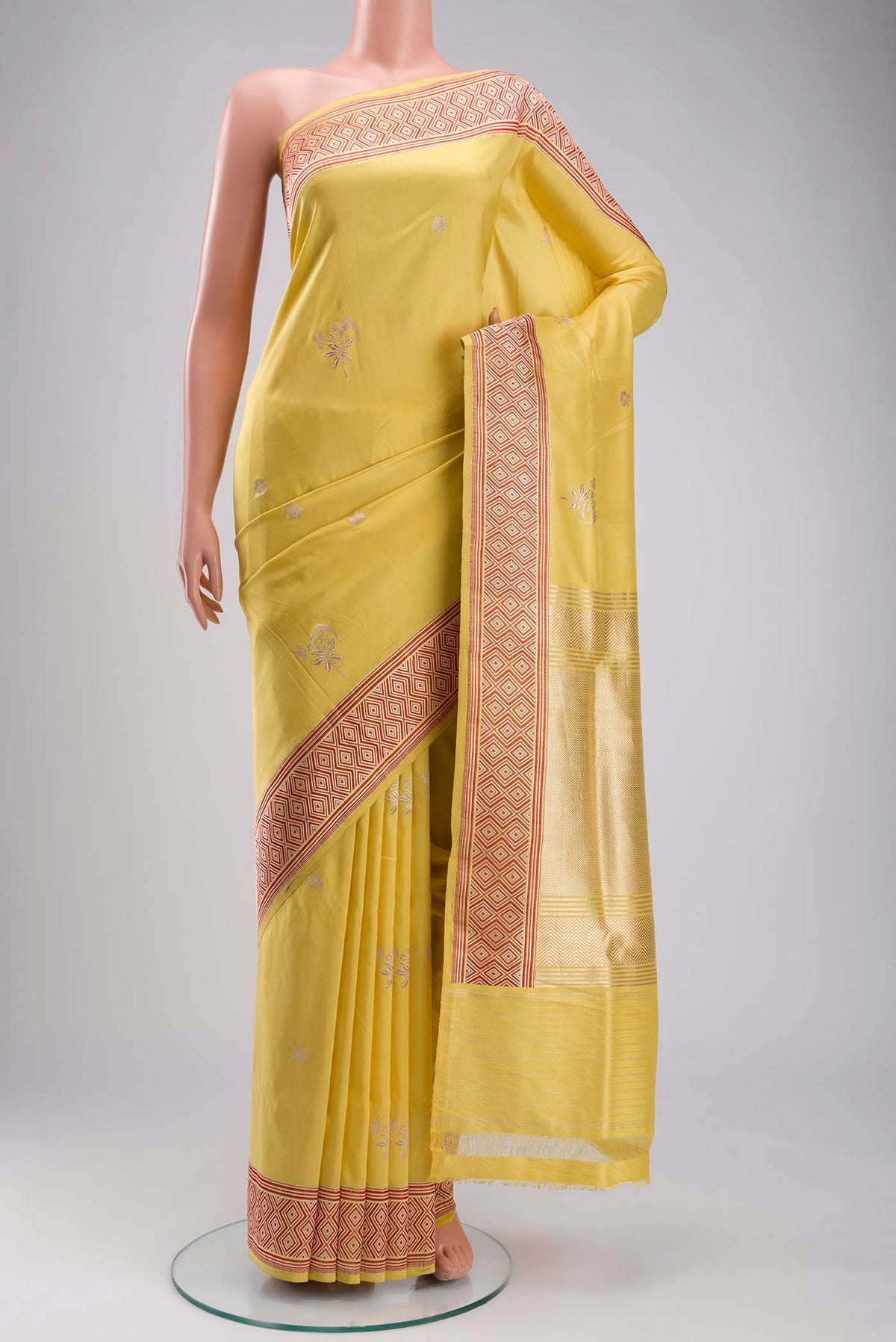 Yellow Banarasi Silk Saree with Zari Butta on the body and Zari Border displayed on a mannequin