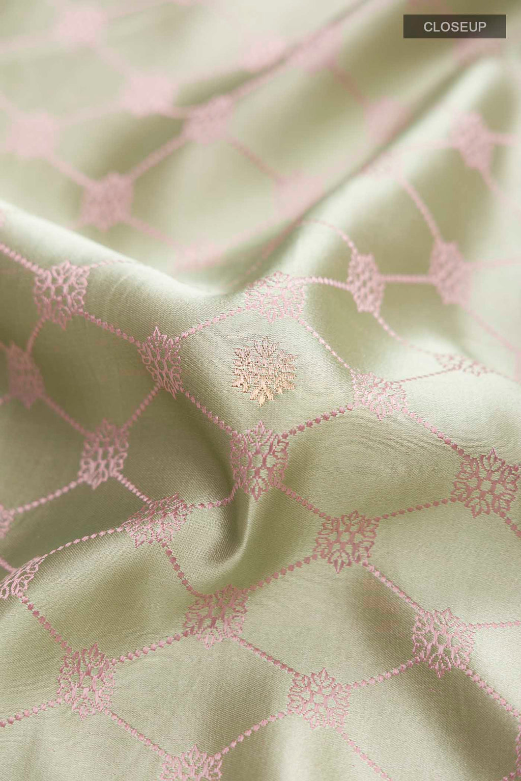 Close up of Green Banarasi Silk Saree with Zari Butta on the body and Zari Border displaying folds