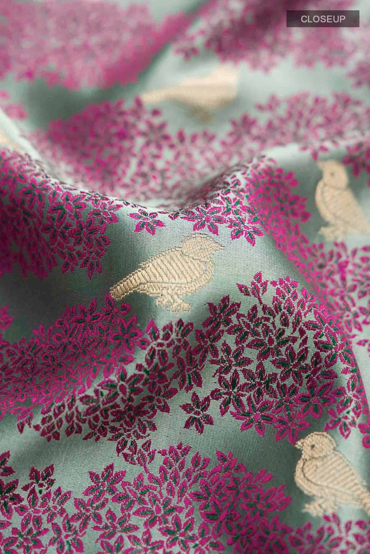 Close up of Sea Green Banarasi Silk Saree with Jacquard With Zari Butta on the body and Zari Border displaying folds