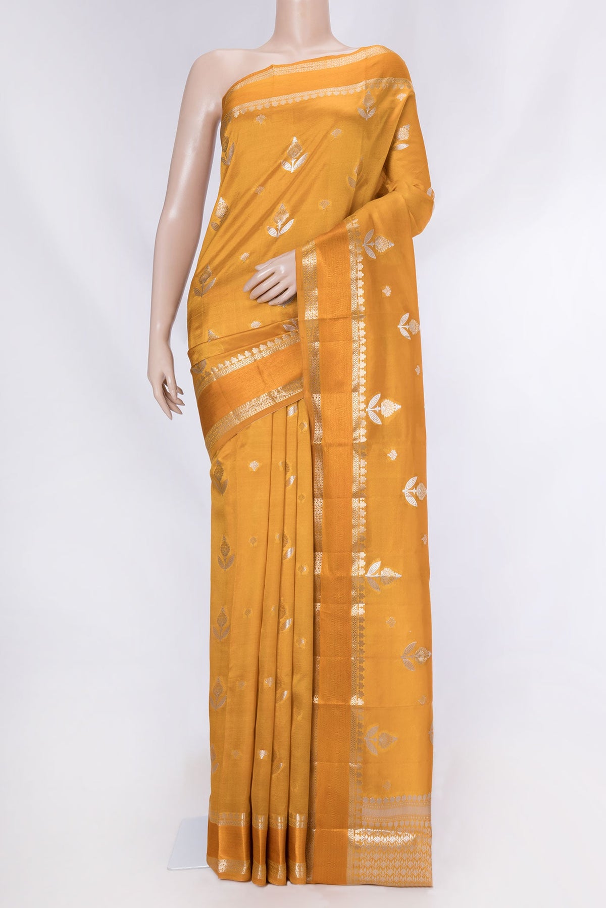 Mustard Banarasi Raw Silk Saree with Zari Butta on the body and Zari And Thread Border displayed on a mannequin