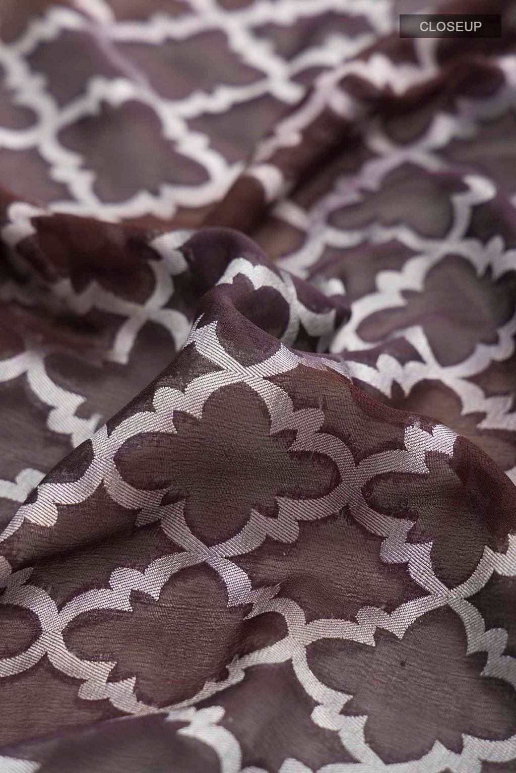 Close up of Brown Banarasi Georgette Saree with Thread Butta on the body and Thread Border displaying folds