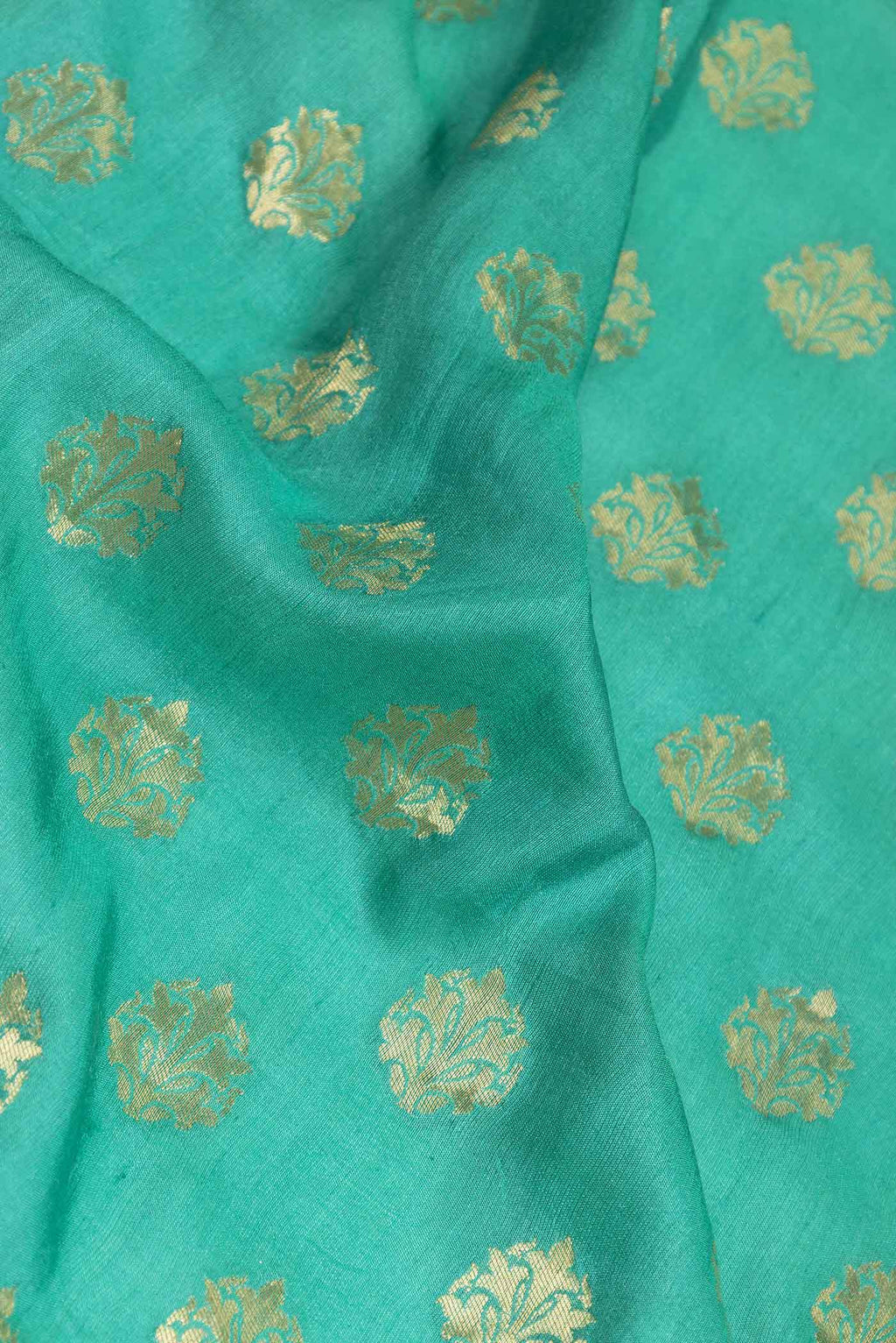 Close up of Green Dual Tone Banarasi Silk Saree with Zari Brocade on the body and Zari Border displaying folds