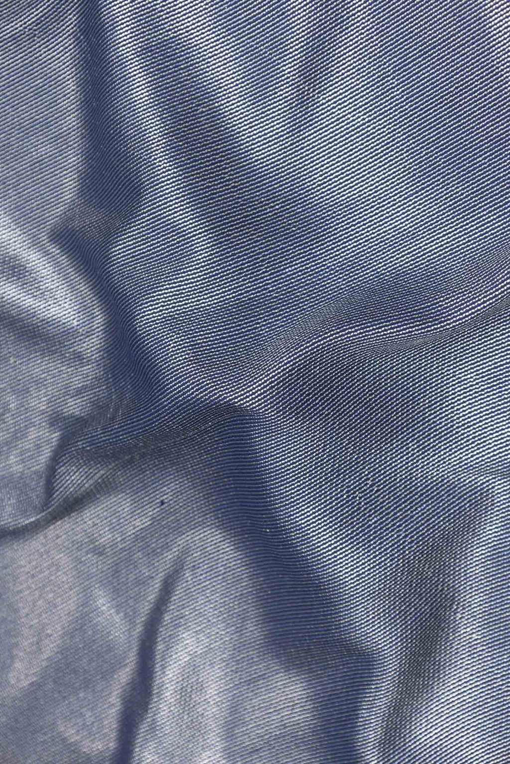 Close up of Navy Blue Dual Tone Banarasi Silk Saree with Zari Brocade on the body and Plain Border displaying folds