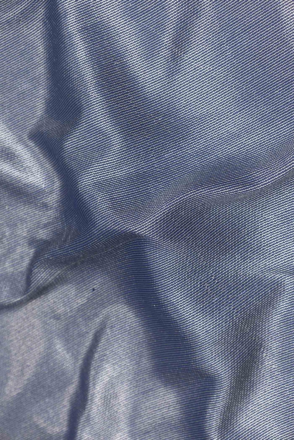 Close up of Navy Blue Dual Tone Banarasi Silk Saree with Zari Brocade on the body and Plain Border displaying folds