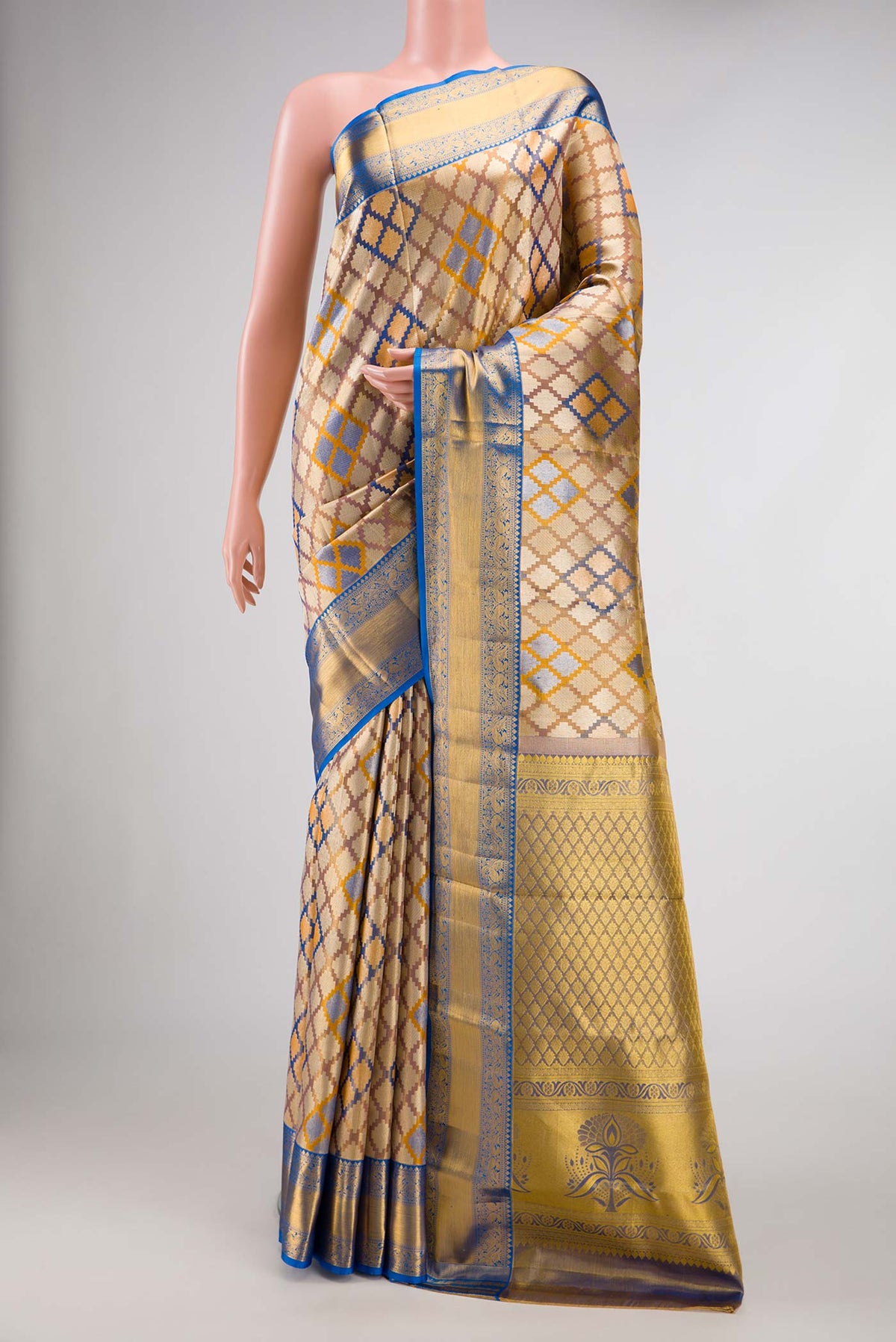 Gold Dual Tone Kanjivaram Tissue Silk Saree with Zari Brocade on the body and Zari Border.  displayed on a mannequin