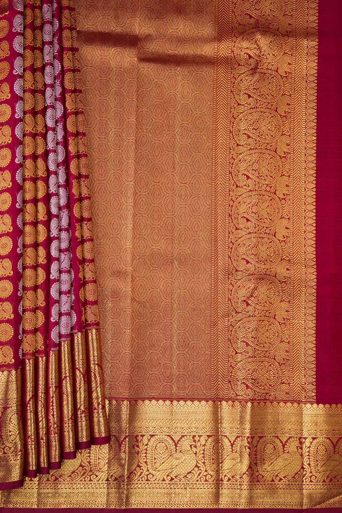 Pleats and pallu of Maroon Dual Tone Kanchipuram Silk Saree with Zari Brocade on the body and Zari Border. 