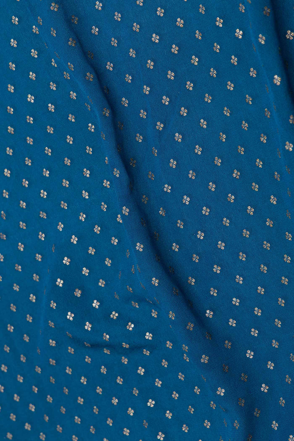 Close up of Peacock Blue Dual Tone Georgette Saree with Zari Butta on the body and Zari Border displaying folds