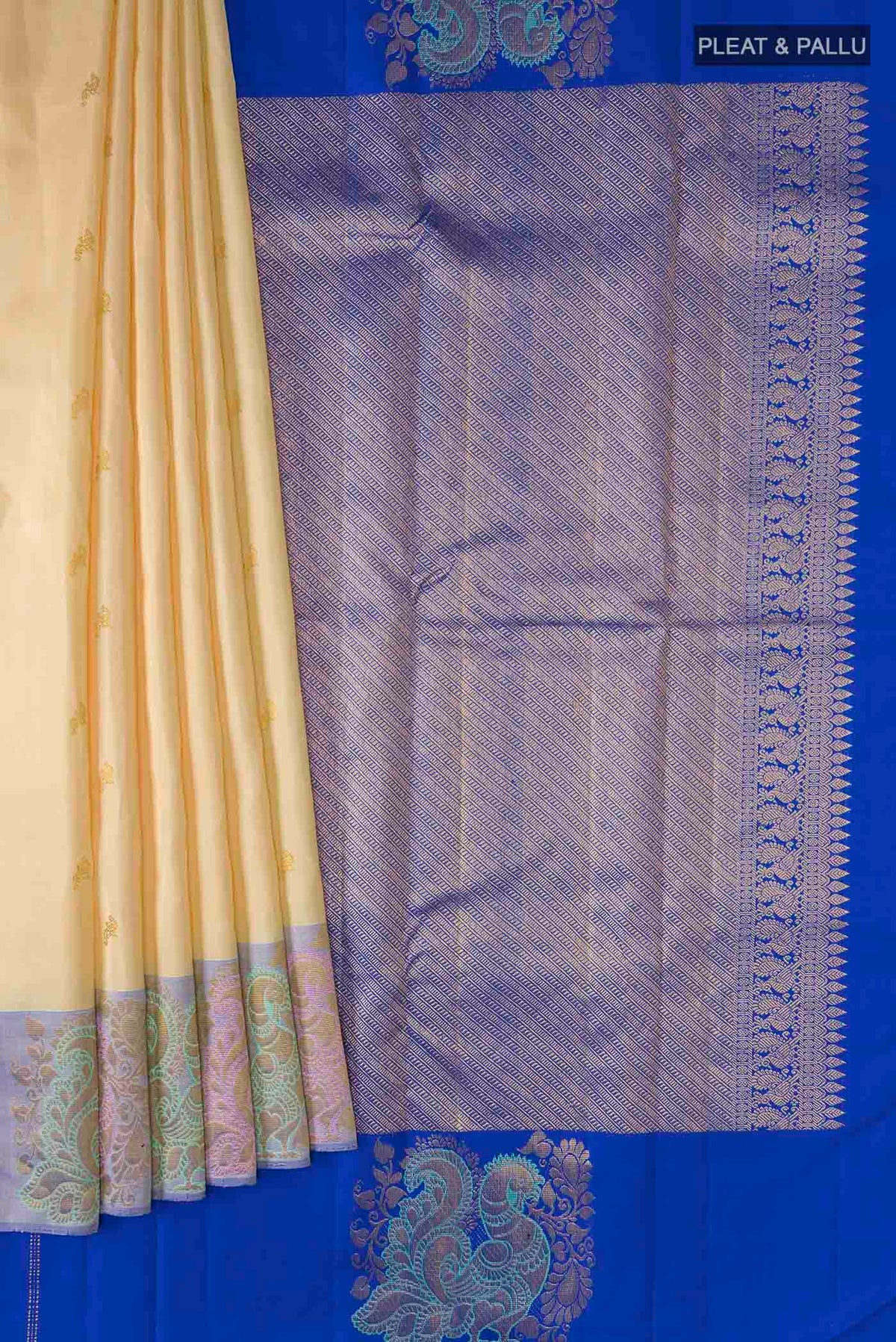 Pleats and pallu of Cream Kanchipuram Silk Saree with Zari Butta on the body and Zari Border